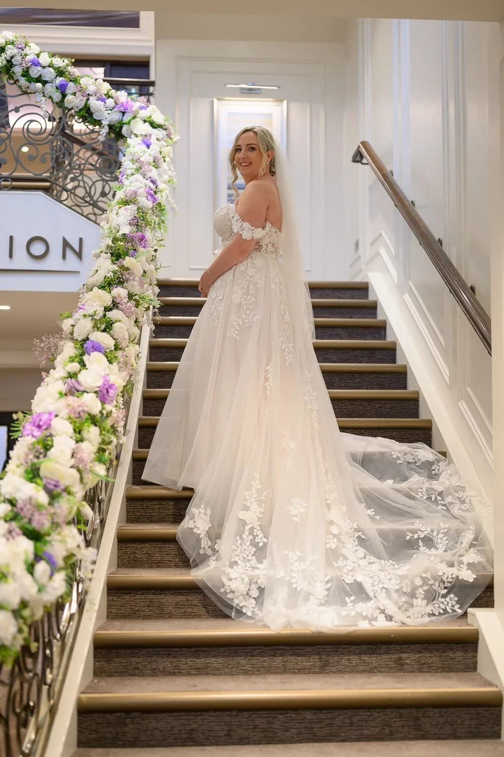 Bride on the staircase inside Seamill Hydro Hotel during her wedding day in West Kilbride.