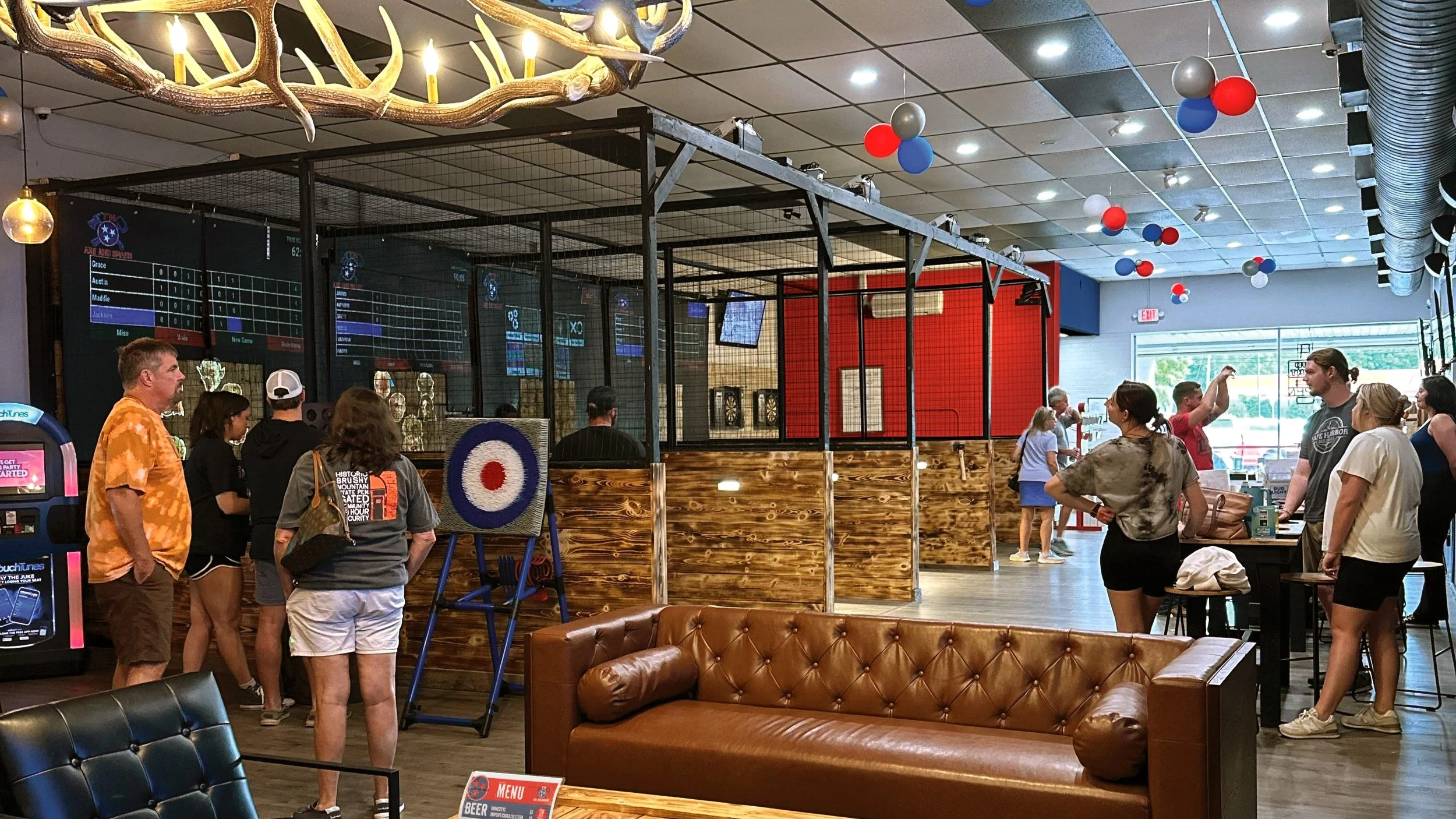 Birthday party group gathered in the axe lanes and lounge area.