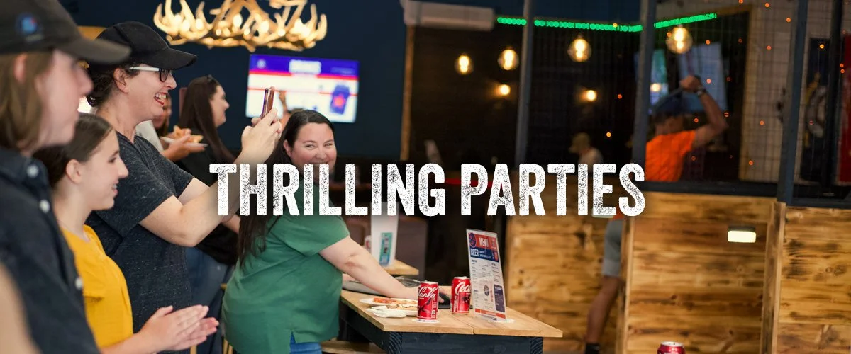 Group of children and adults having fun throwing axes during a party at TN Axe and Smash. 