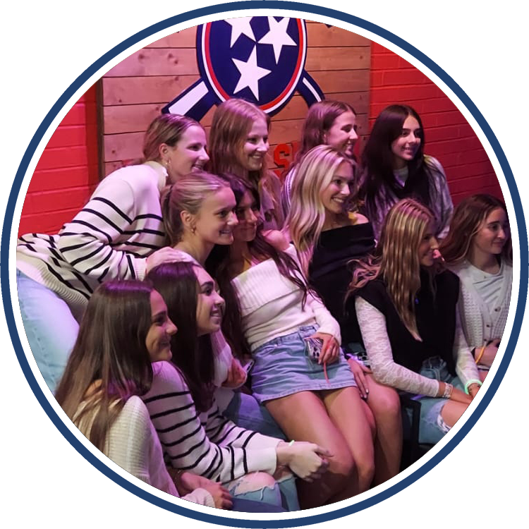 Group of girls poses with smiles in our lobby after having a blast at TN Axe and Smash.