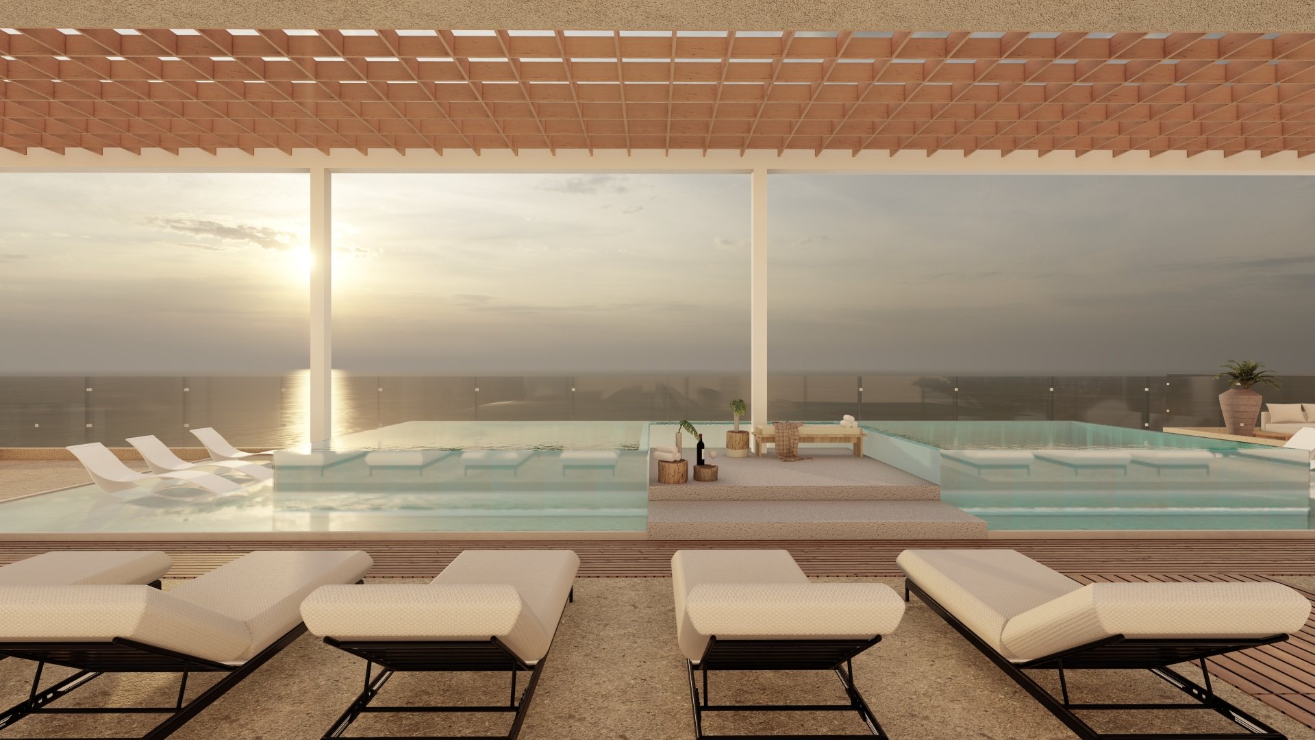Terraza con piscina, camastros y vista al mar al atardecer.