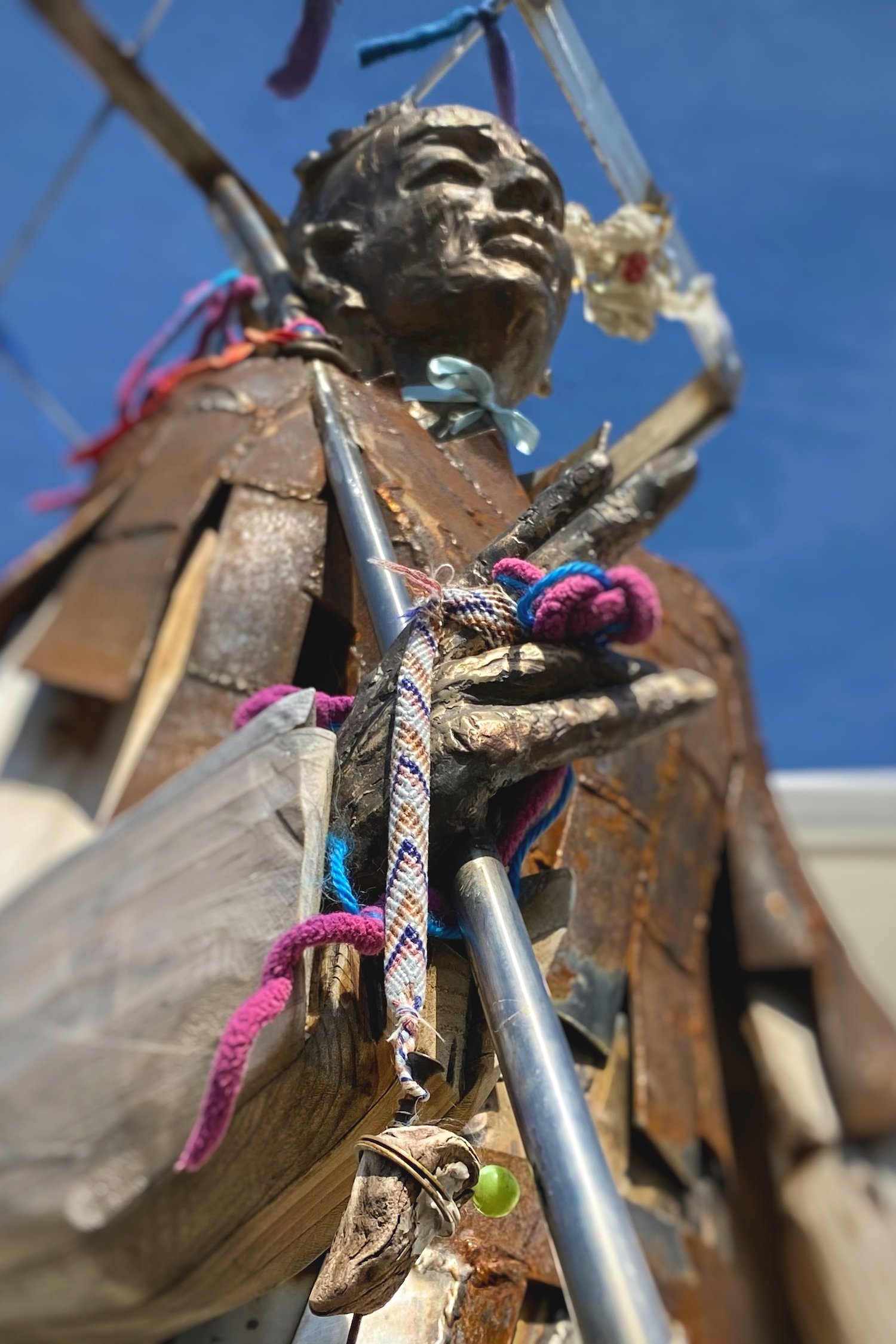 Keeper of Memories sculpture memorial. This sculpture was placed for the community of Hutchinson, MN to remember their loved ones. Here it is with the offerings.