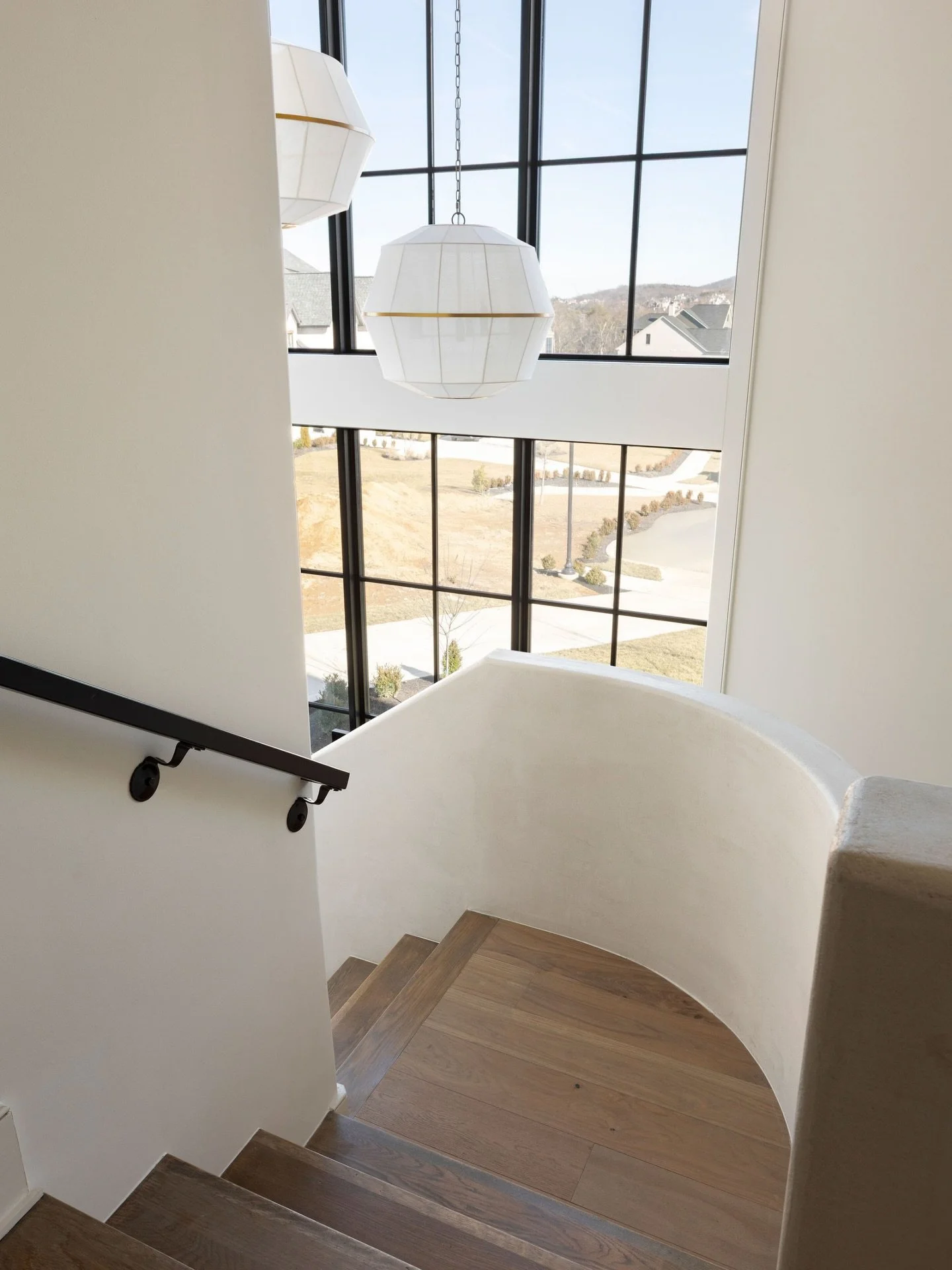 our latest obsession: sculptural stair forms. for a foyer that called for some visual softness, we decided traditional iron railings would distract from the the main focal points as you enter the home and really wanted to accentuate the curve of the 