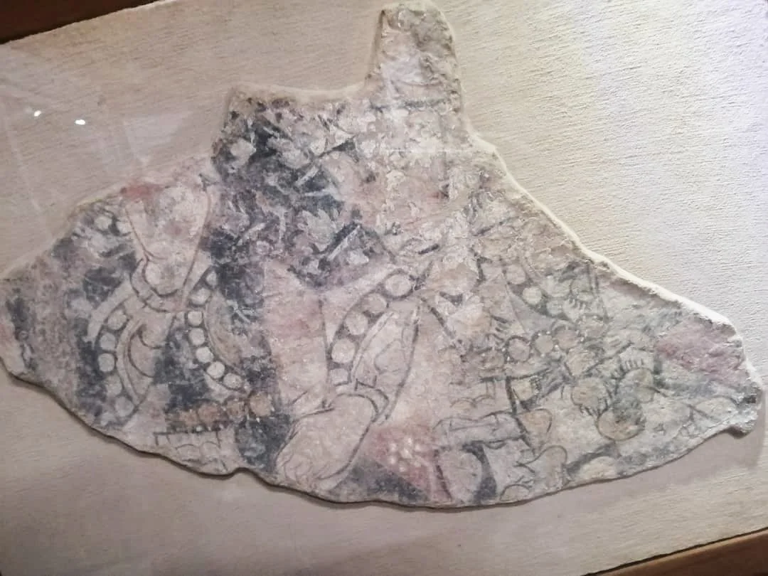 North East Chapel Fresco 
Dilberjin Tepe 
1st century BCE - 1st century CE
Painted clay 

(Fresco Fragment 1) -  A high dignitary wearing pointed shoes and baggy trousers. Below, the row of pearls and the head and man on the lower part of the fresco.