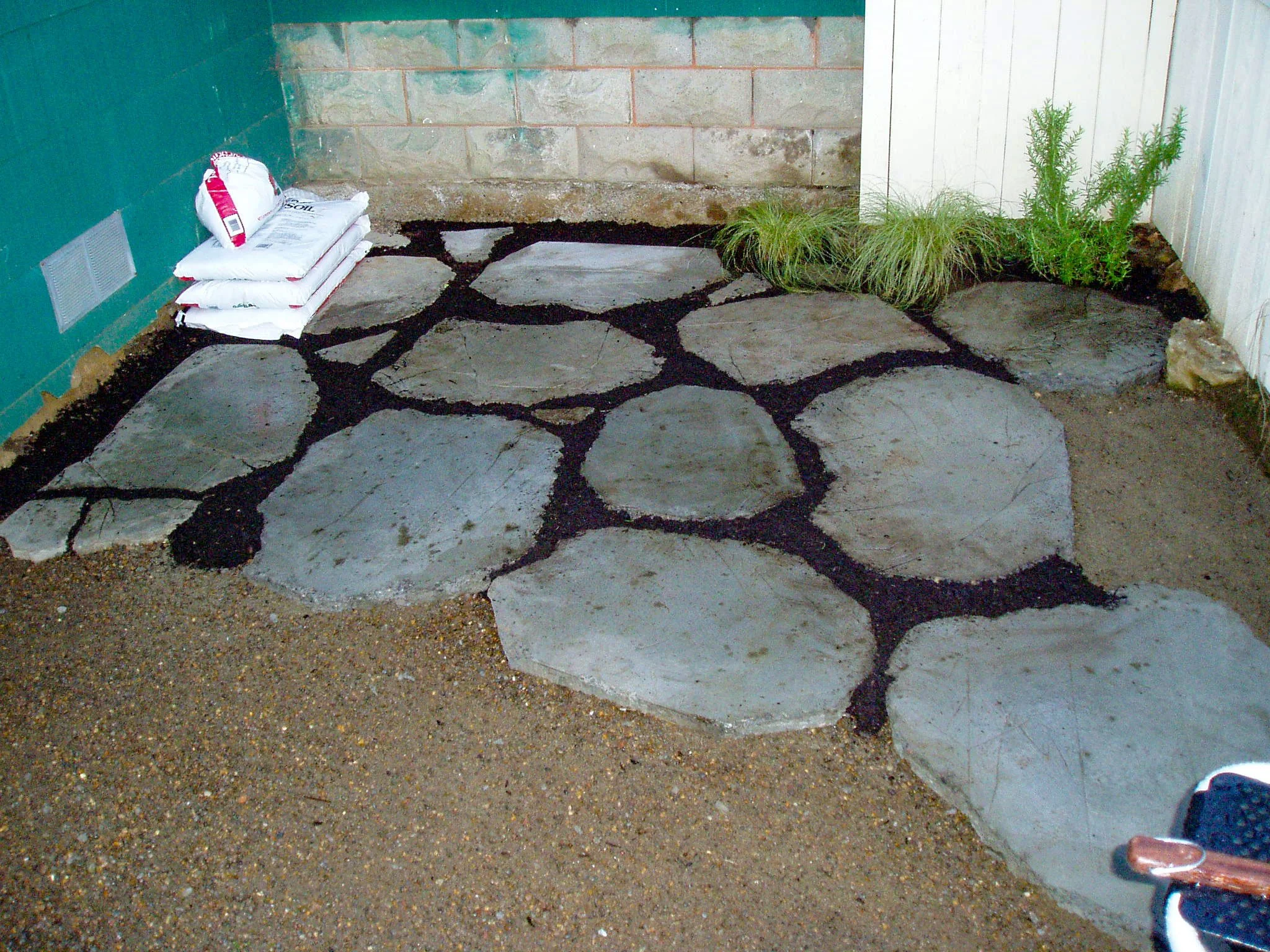 Installing the pavers and composing soil for step-ables to grow between