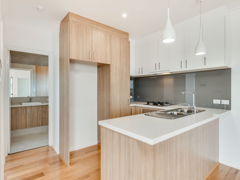 Apartment kitchen design with oak cupboards