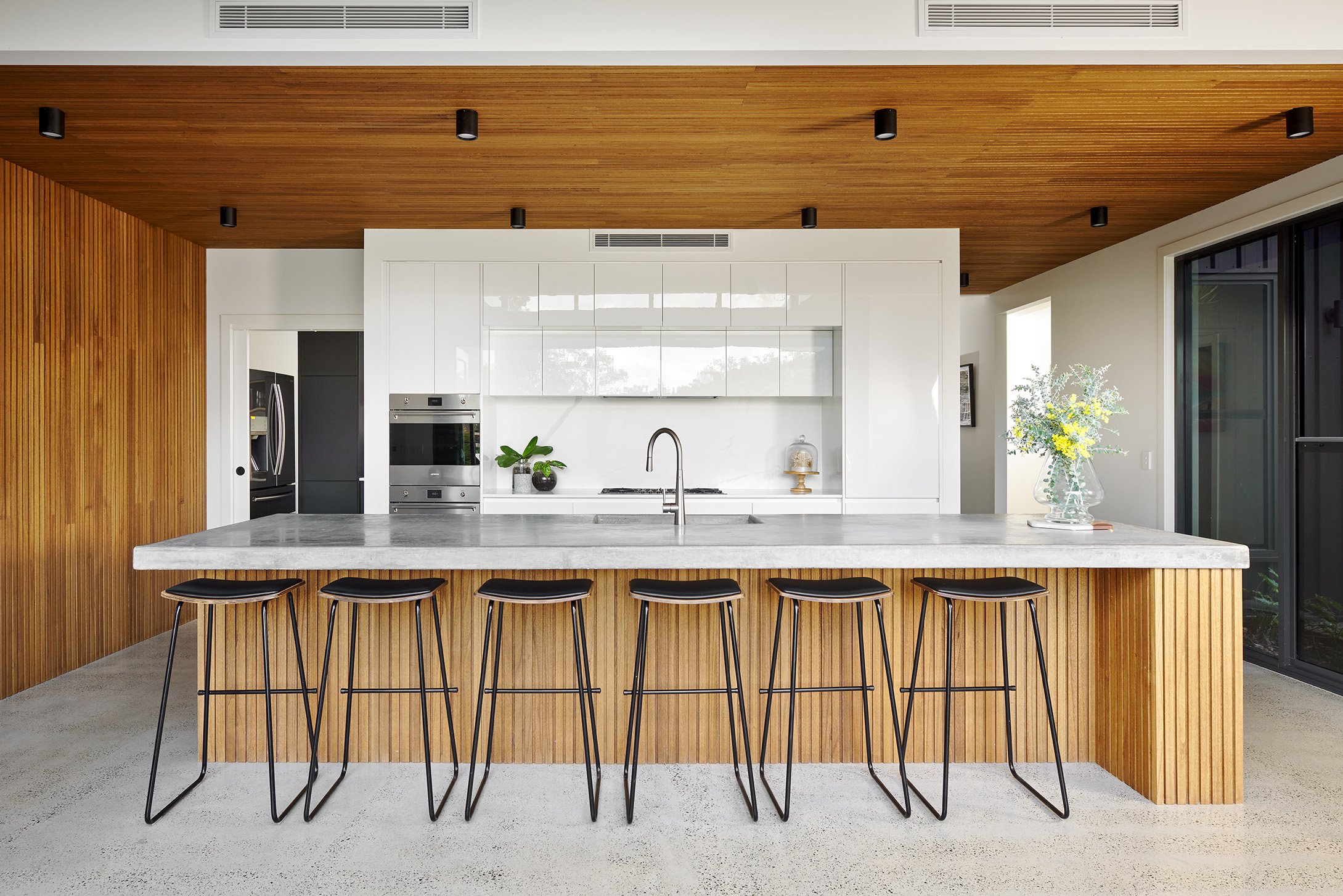 Modern kitchen with spotted gum cabinets and ceiling