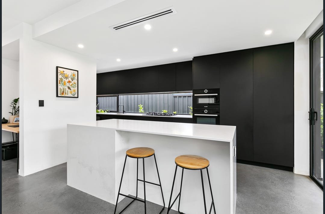 Contemporary kitchen design with window splash back