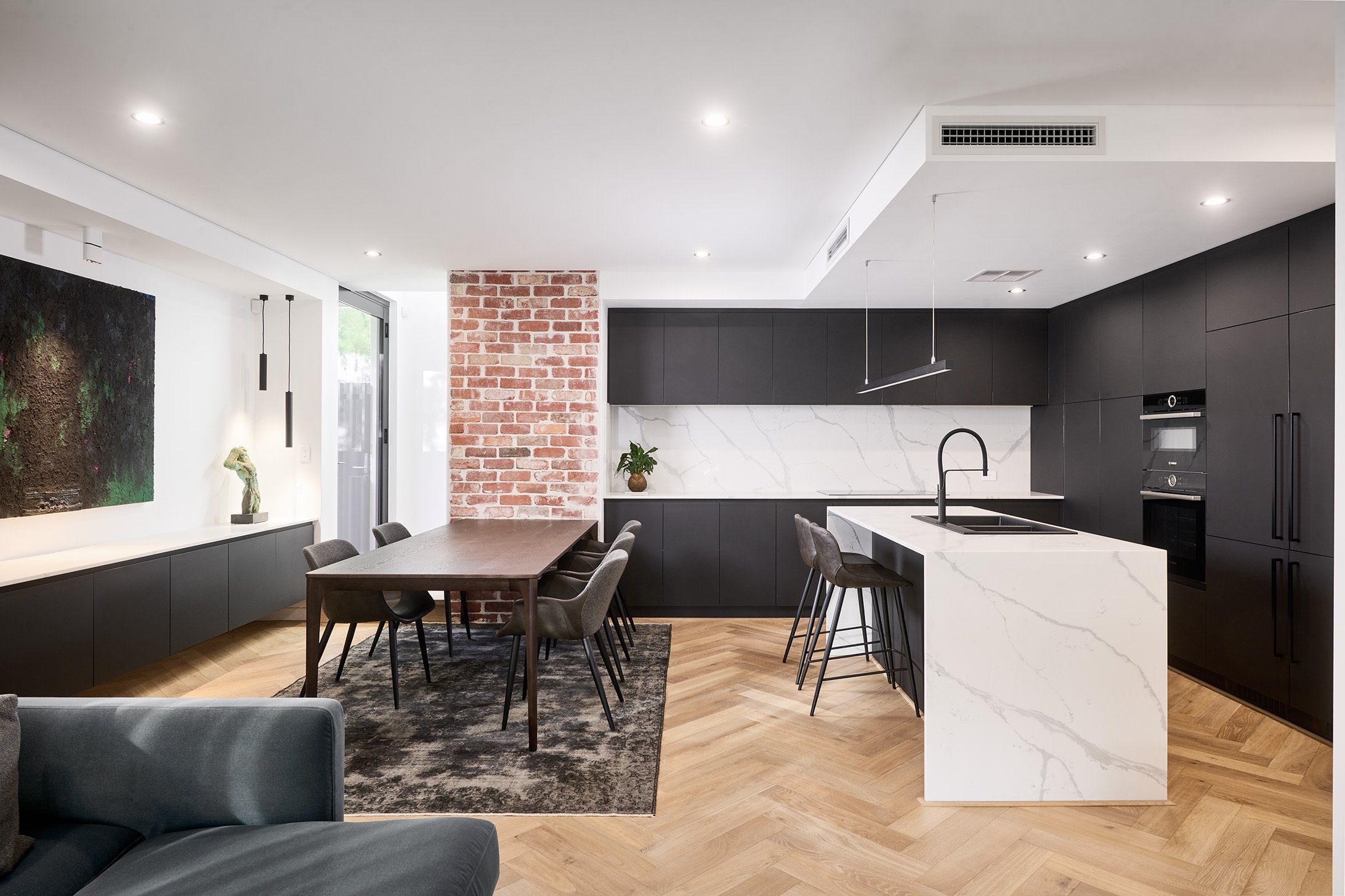 Modern monochrome kitchen with recycled face brick and smart sone benchtops