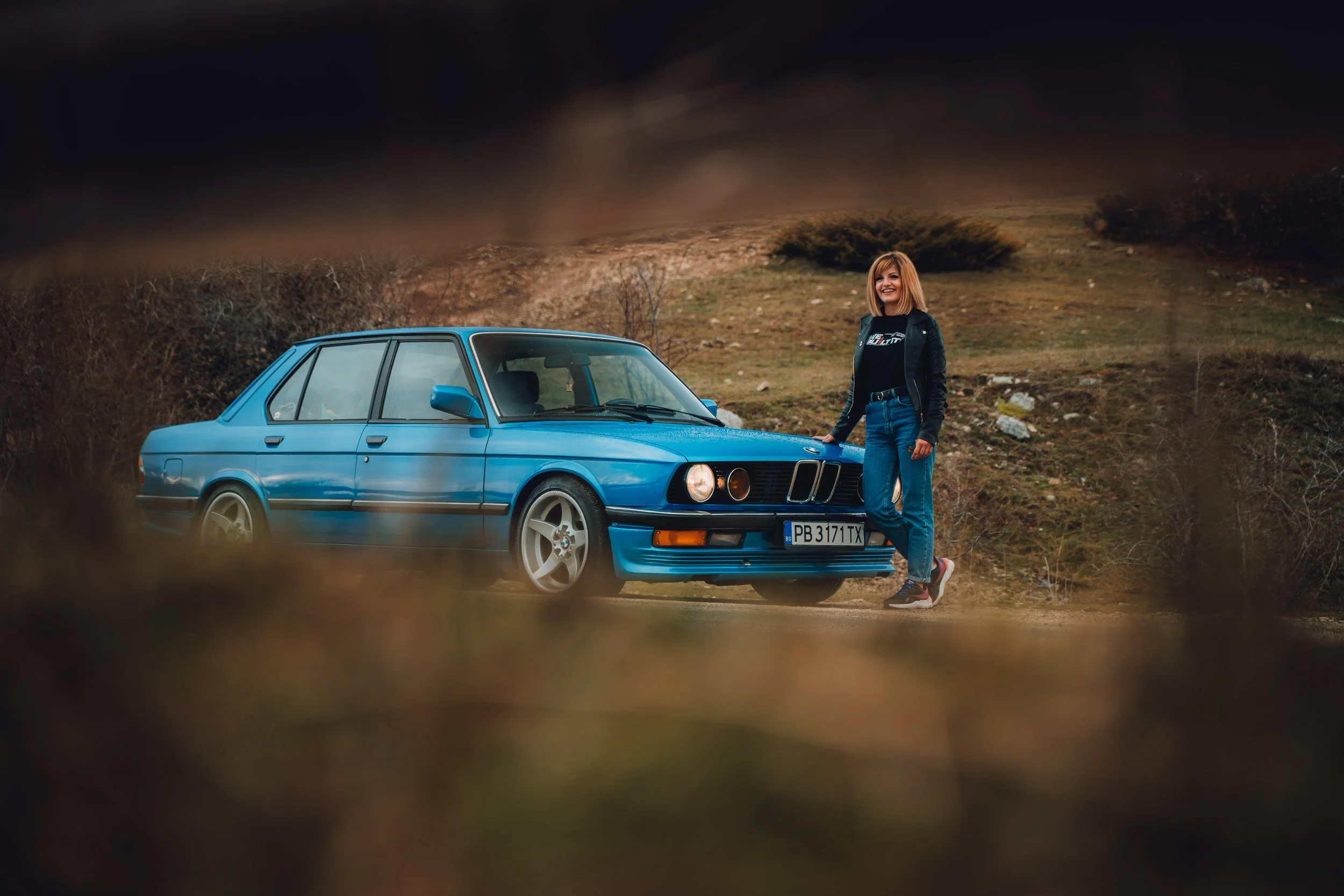 Girl standing next to car