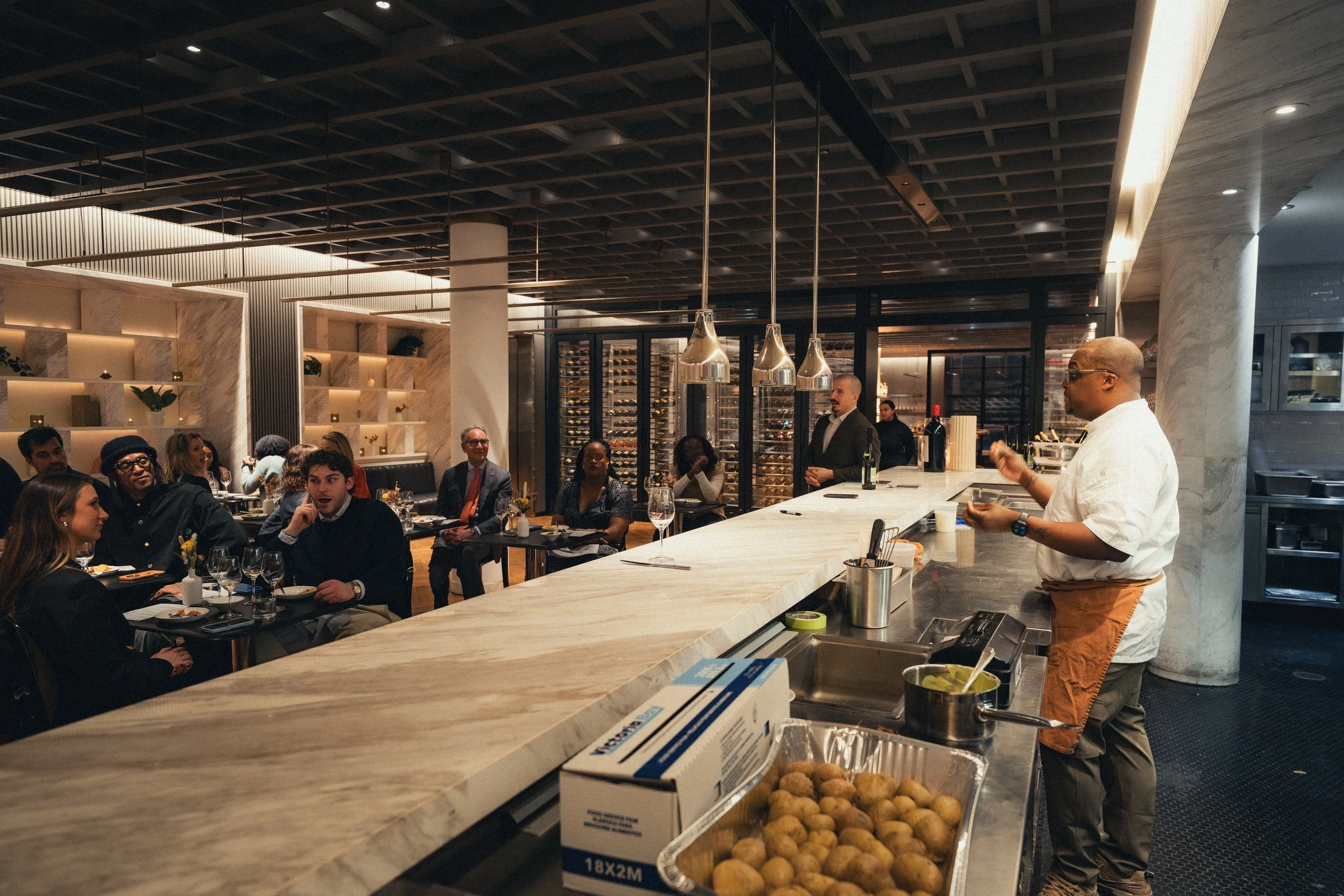 Interior of Meatpacking Collective showing sleek marble and stainless steel finishes during a corporate dinner event. The perfect venue for a chic work dinner.