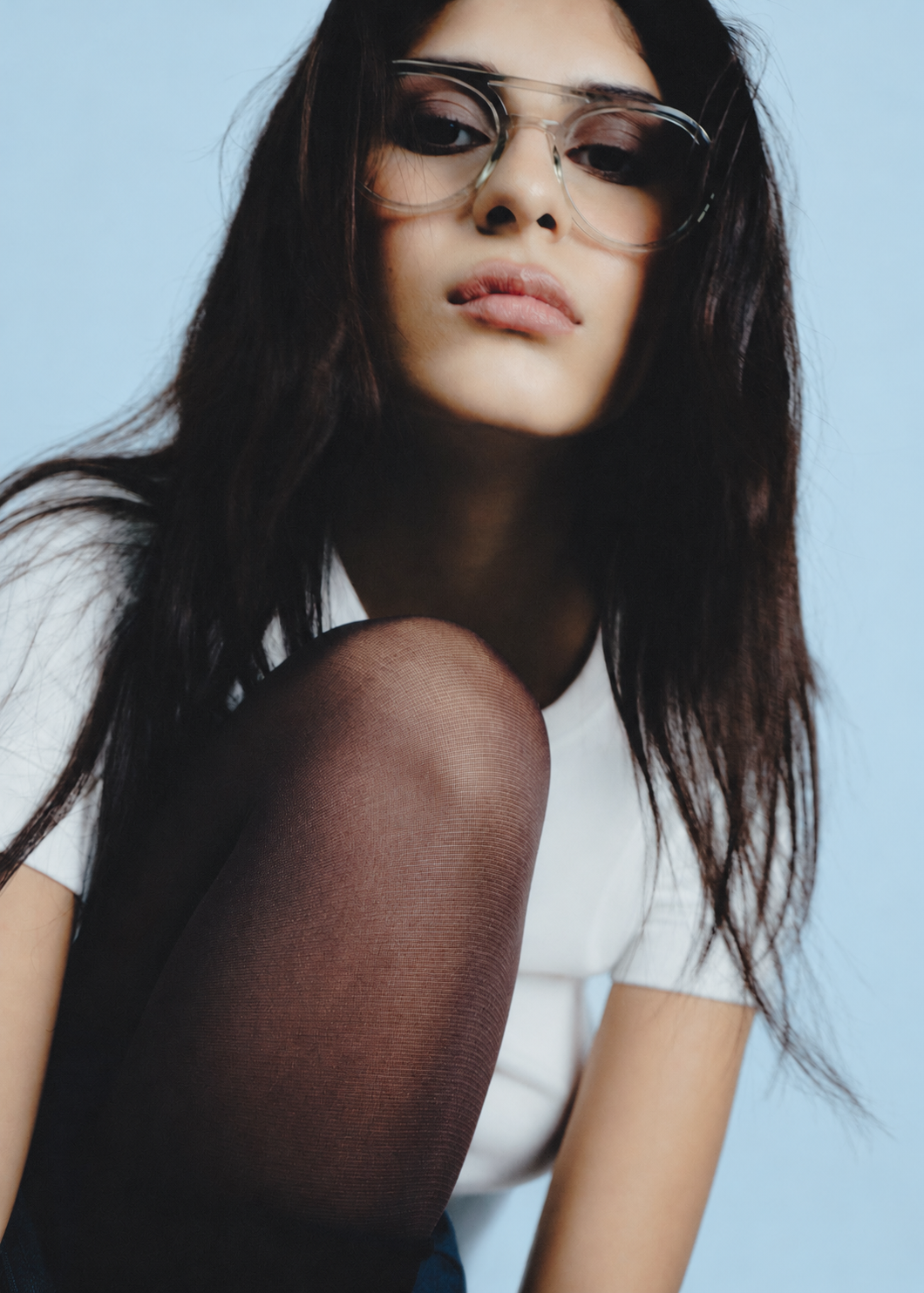 Model on a pale blue seamless backdrop.png