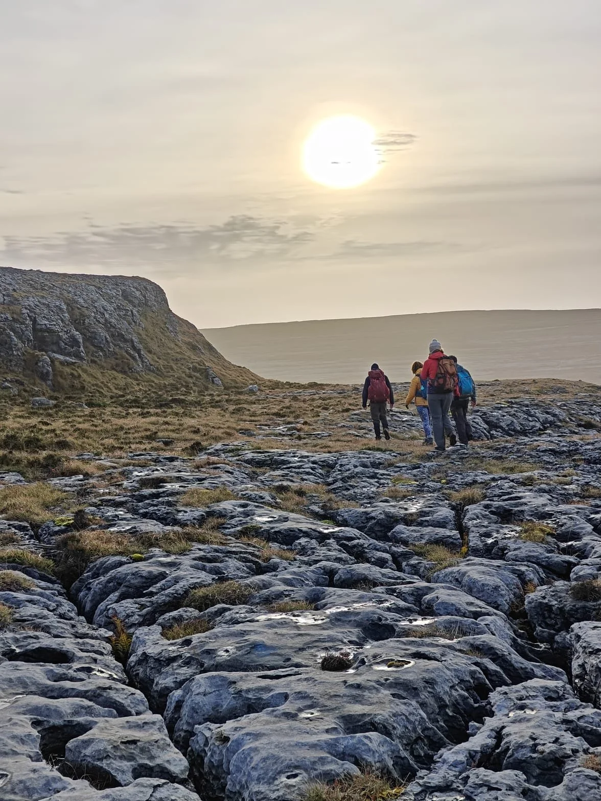 limestone pavement with people hiking in the distance