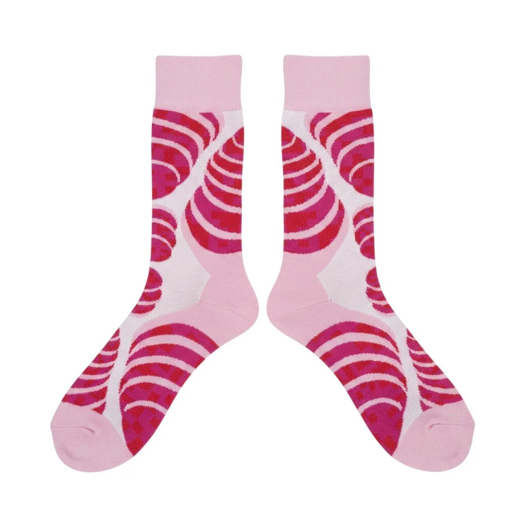 Echo Knits crew socks in pink and red with layered swirl knit pattern, flat lay product shot