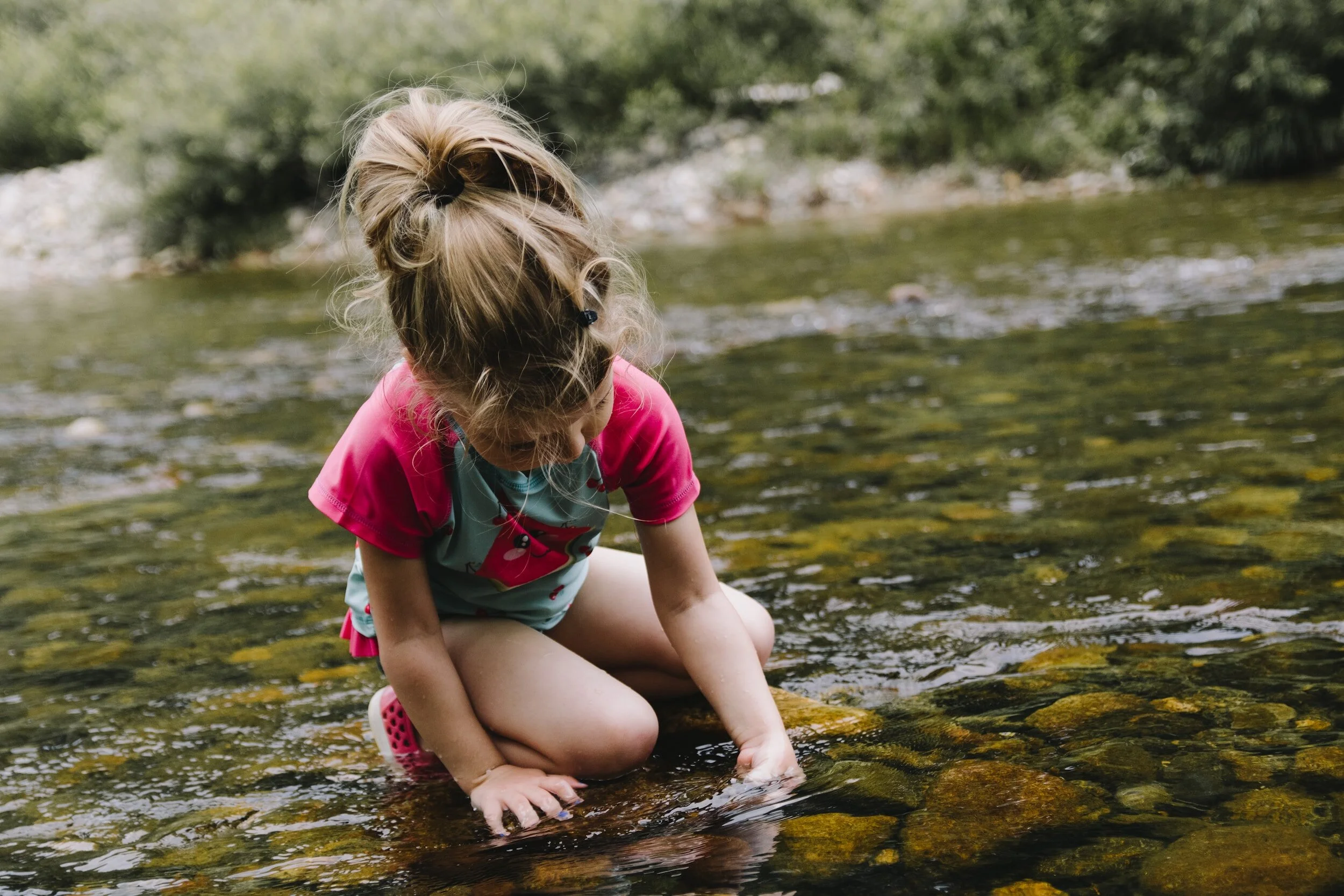 girl playing in stream