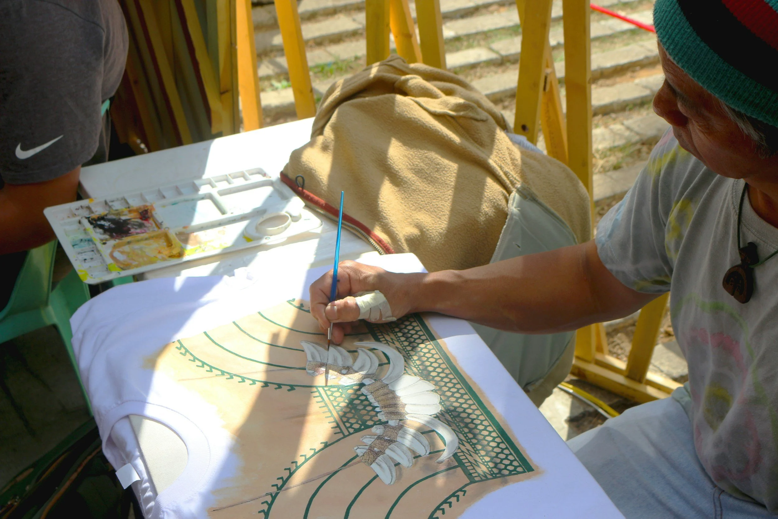 Someone painting on a shirt