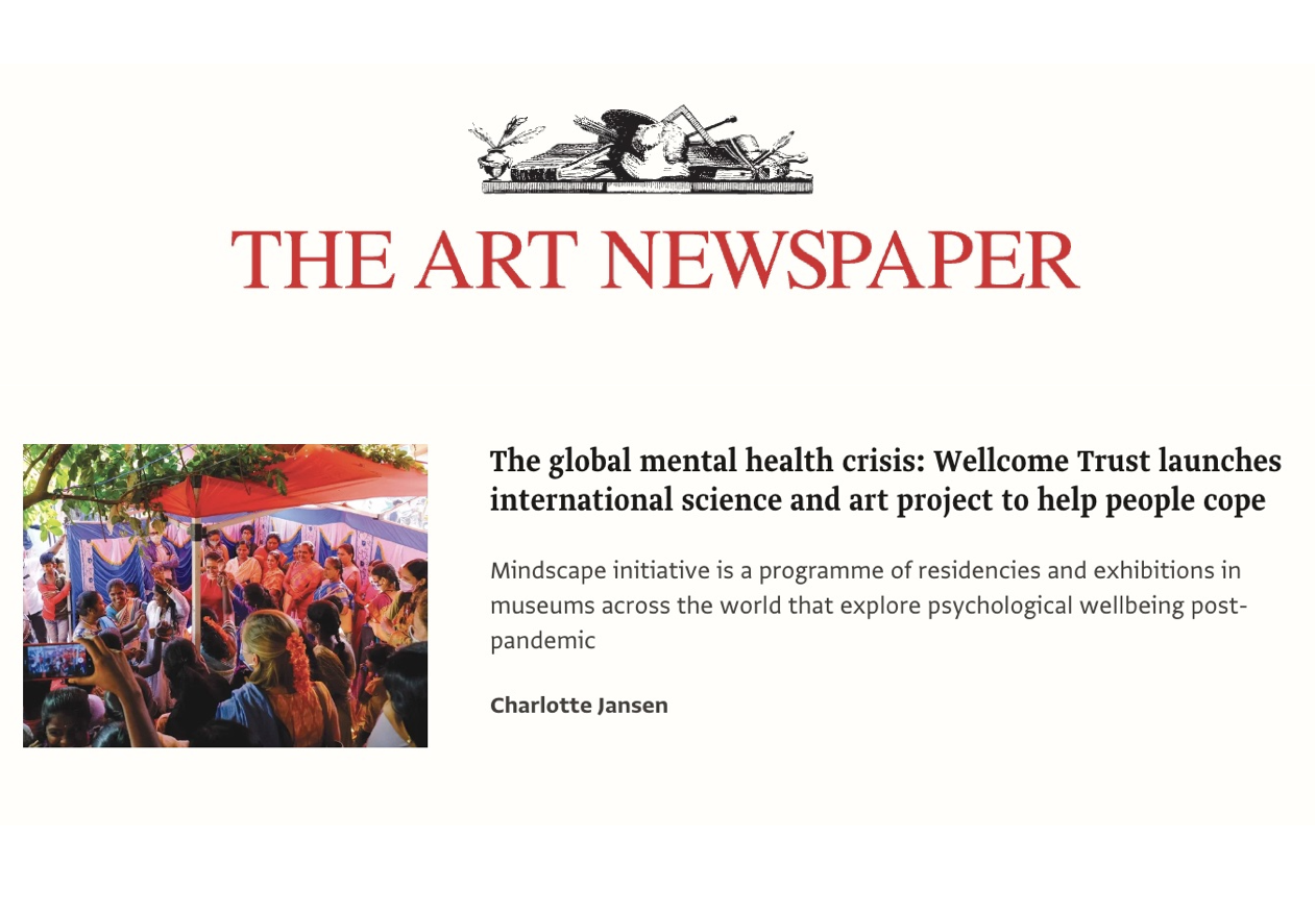 Cover page of The Art Newspaper with article about a mental health initiative involving a colorful outdoor gathering of people, mostly women, under red and orange umbrellas.