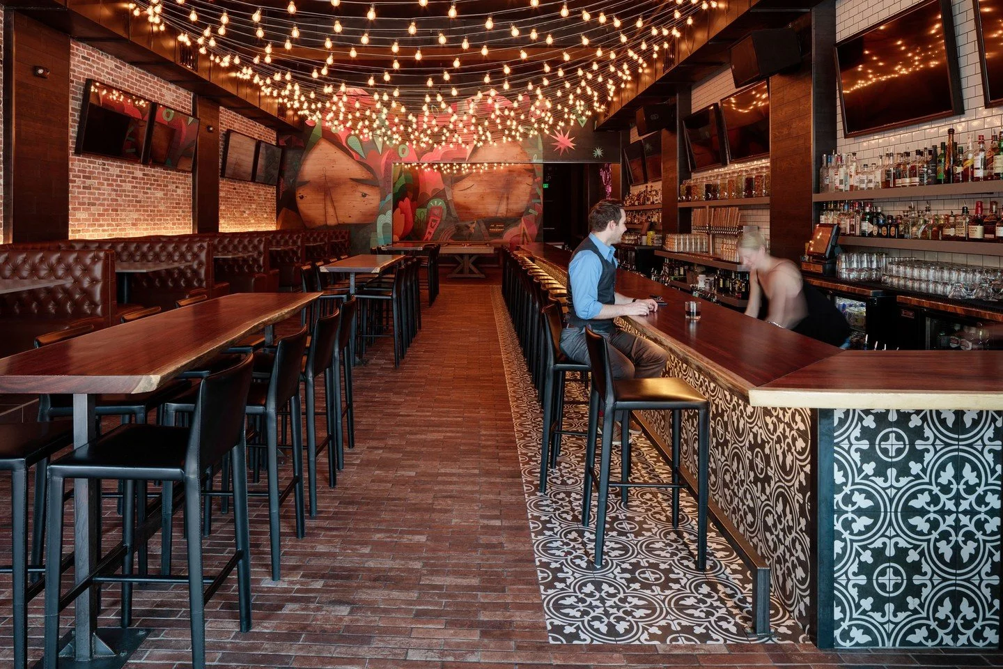 Under a blanket of 900 LED string lights you can find the unique bar aptly named Canopy. 

#interiordesign #bardesign #patternedtiles #mural #lighting