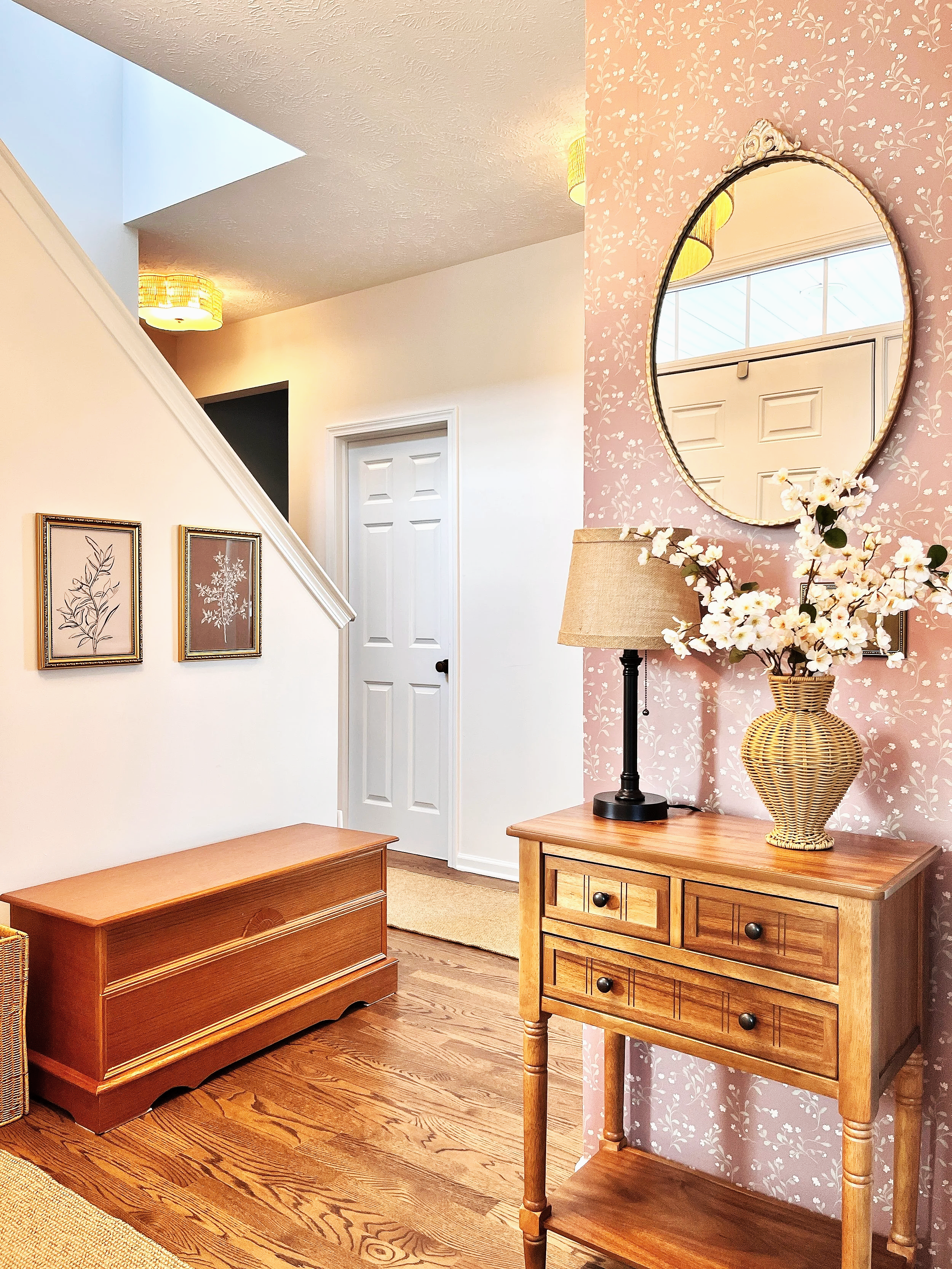 elegant foyer with soft colors and warm wood tones freshly repainted, wallpapered, and redecorated