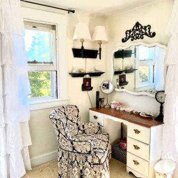 Dressing room makeover included:
New paint, new draperies, new rug, new shelving and storage bins, refinished vanity, second-hand chair, refinished fixtures, custom decor from thrifted items.