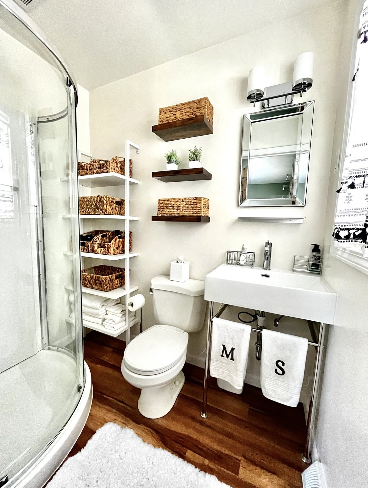 Bathroom makeover included:
Complete demo of old tub and tile, new shower, new sink and fixtures, all new decor, new floor, new draperies, new storage and new lighting.