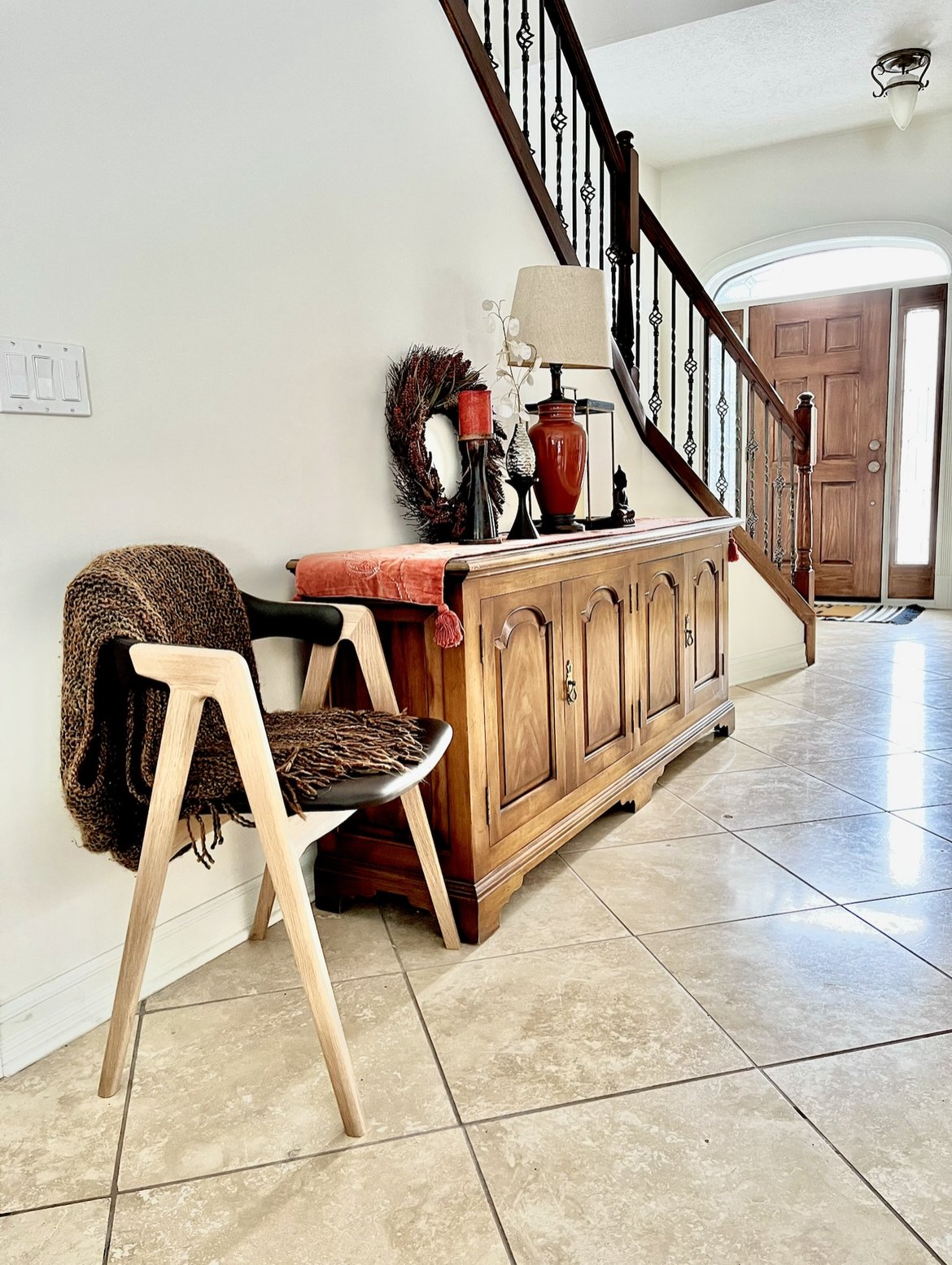 Foyer makeover included:
Fresh paint, second-hand sideboard, thrifted decor, repurposed dining chair from owner's expandable table.