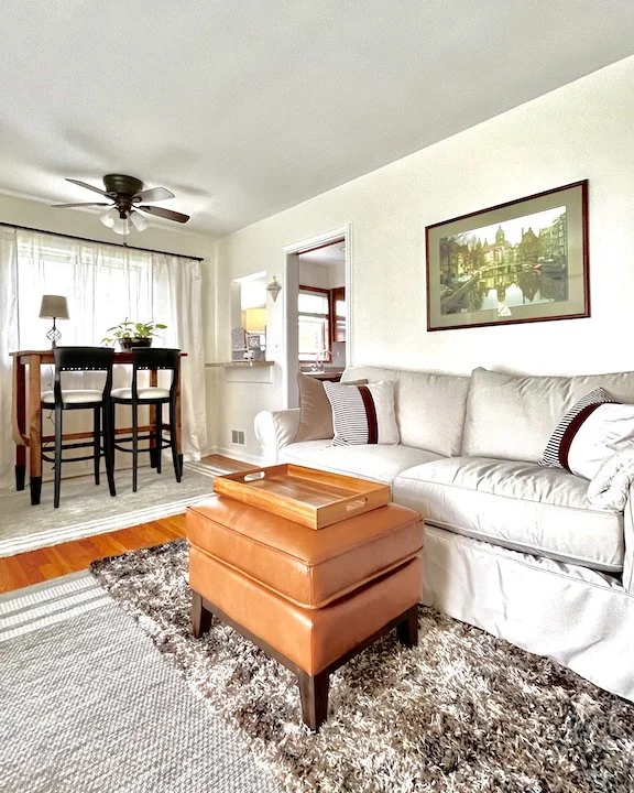 A beautifully decorated room that features neutral furnishings in a variety of textures and. layers