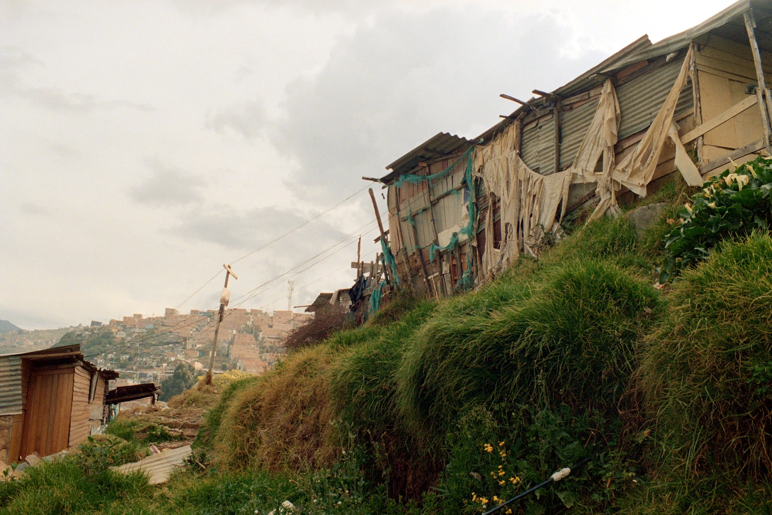 Flimsy houses built at the edge of a cliff. 