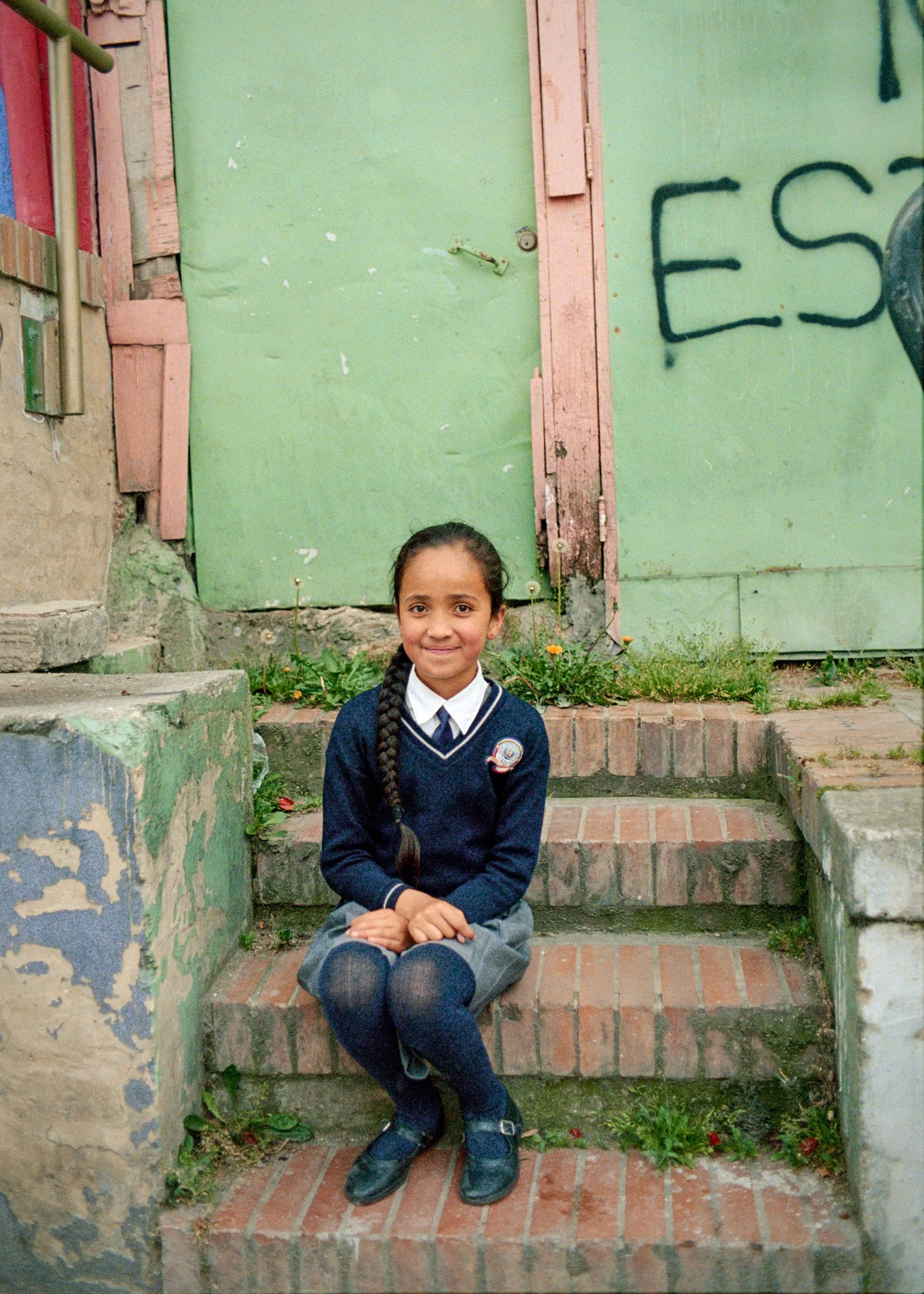 Young girl resting on her way home from school. 
