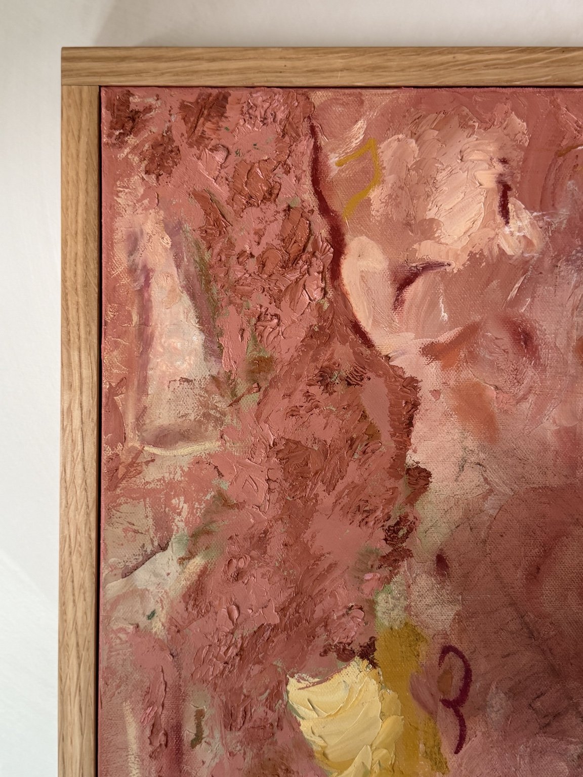Rose-toned detail of an original Jae Whitney painting framed in white oak