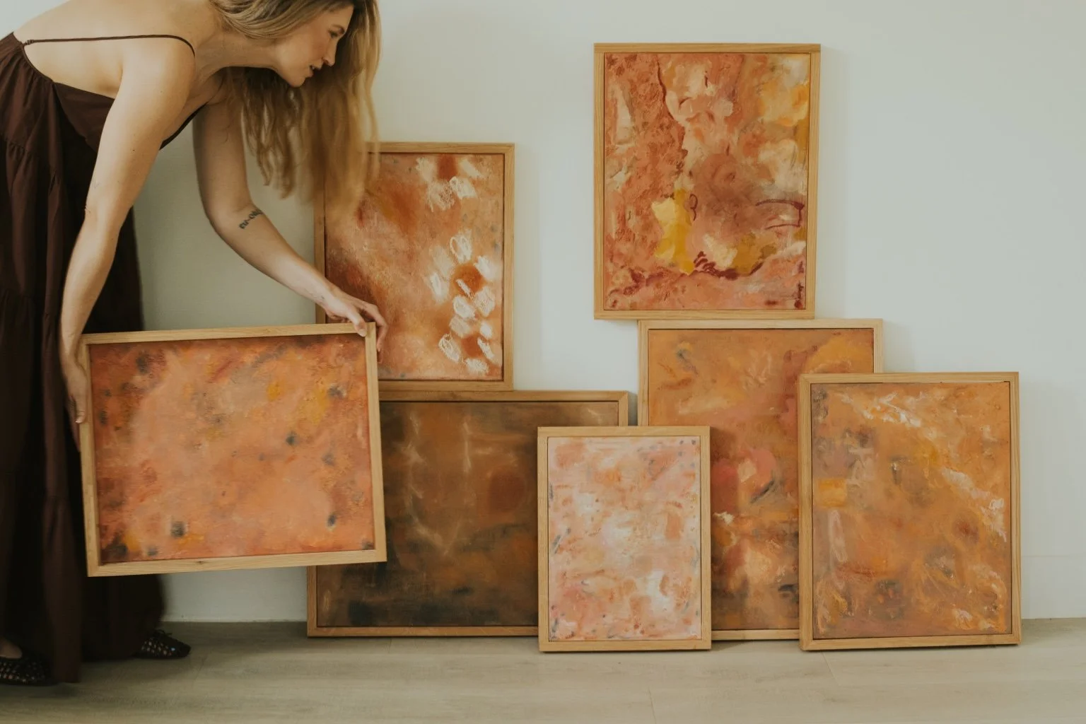 Whitney arranging paintings from the Quiet Sedona collection
