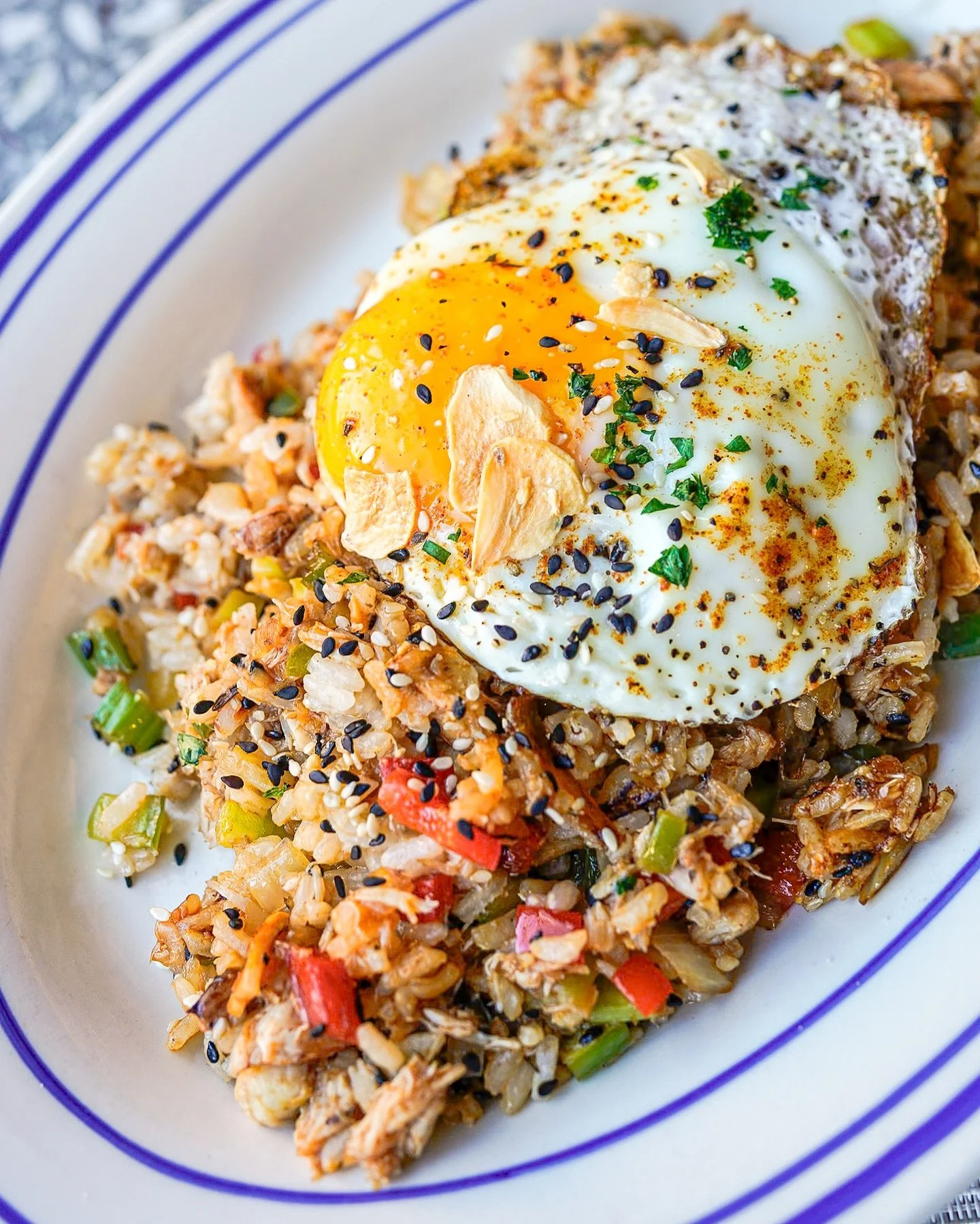 Rice, spice, and everything nice 🦀🍳 our Low Country Crab Rice brings the flavor with Charleston Gold Rice, Bell Peppers, Onions, Celery, Bacon, Claw Crab Meat, Fried Egg, Crispy Garlic &amp; Sesame Seeds.