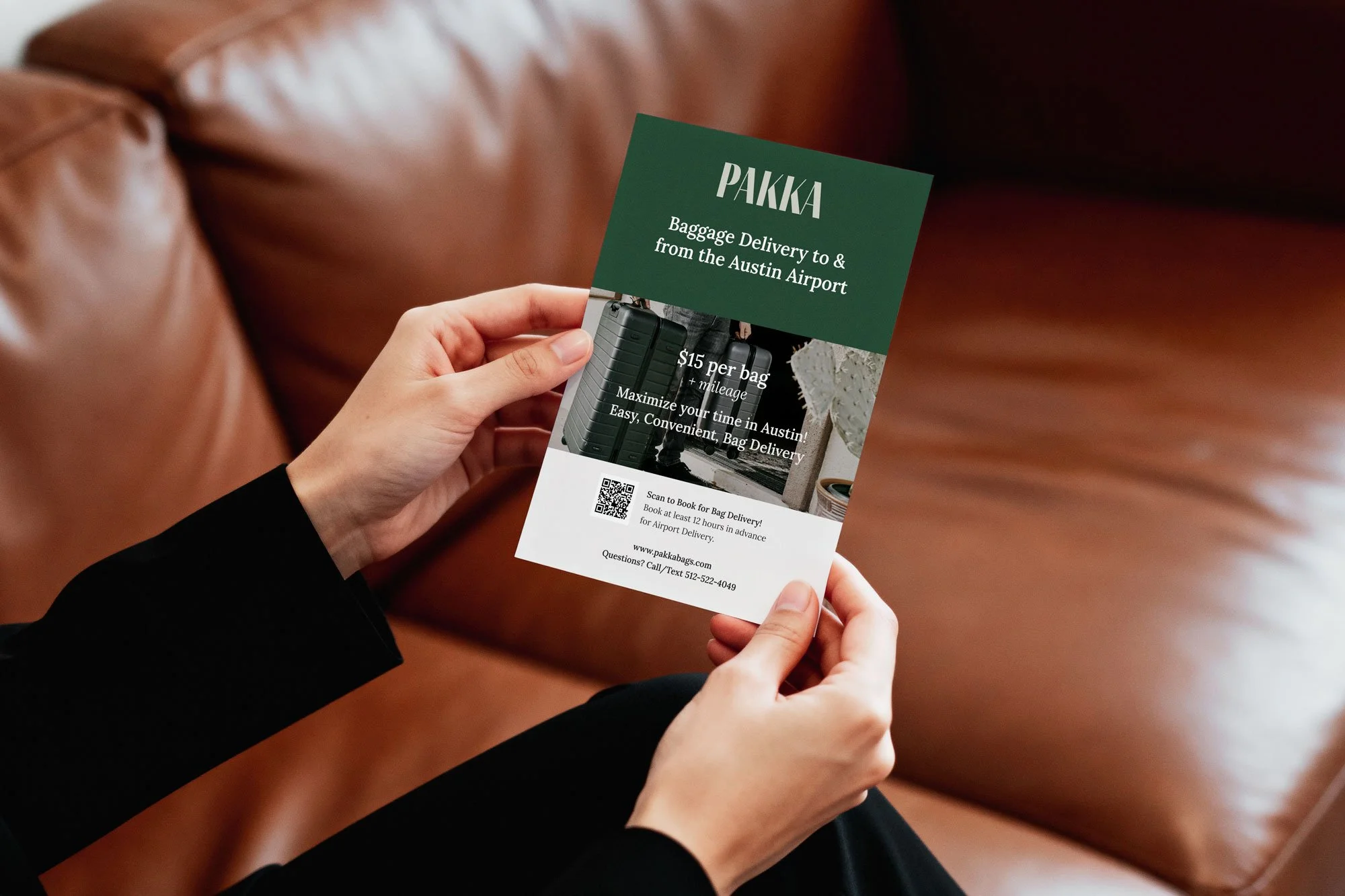 A person holding a flyer that advertises baggage delivery services from Austin Airport by Pakka, with details about pricing, booking, and a QR code for booking.