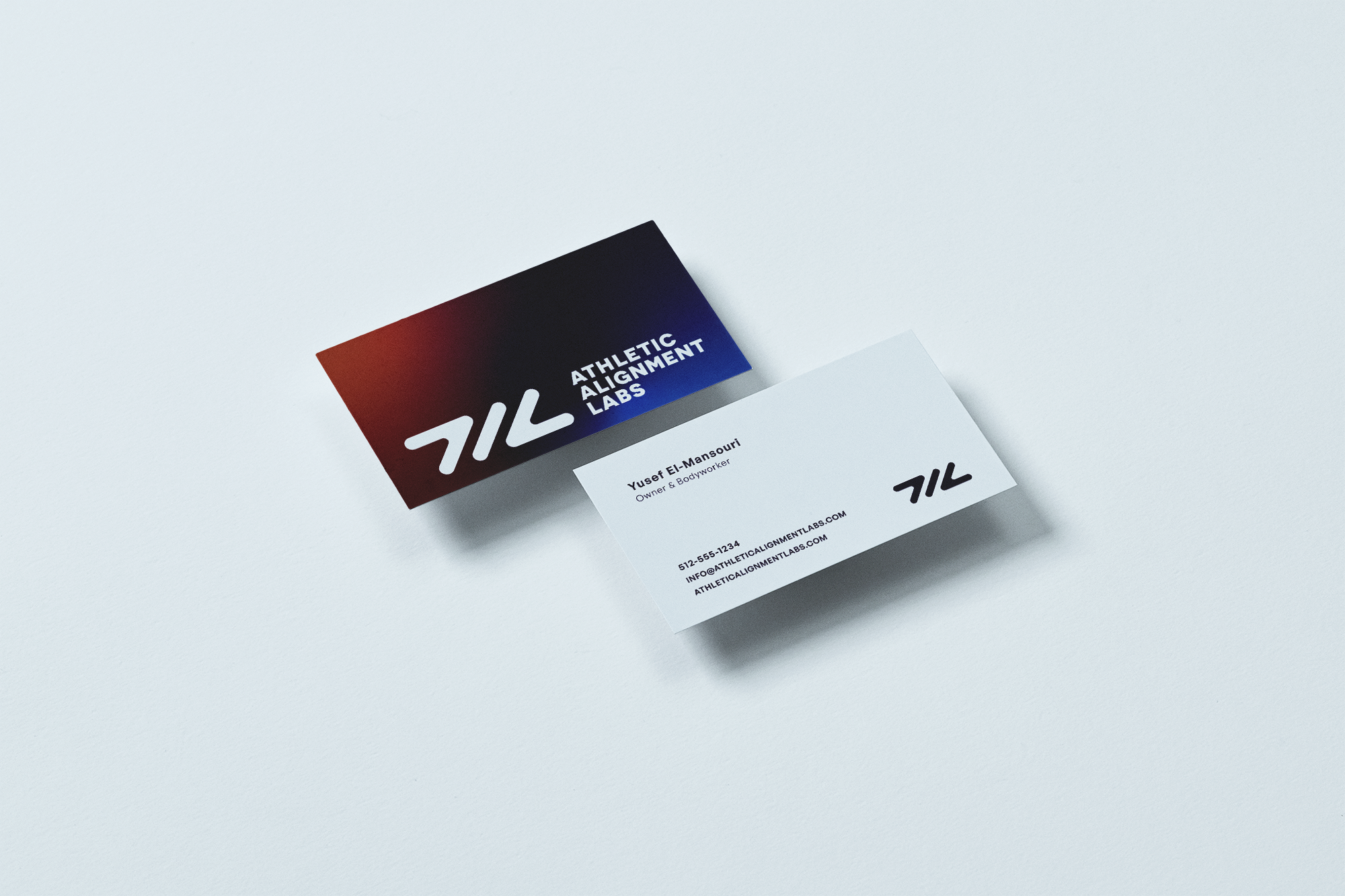 A business card with the logo and name of Athletic Alignment Labs on a white surface.