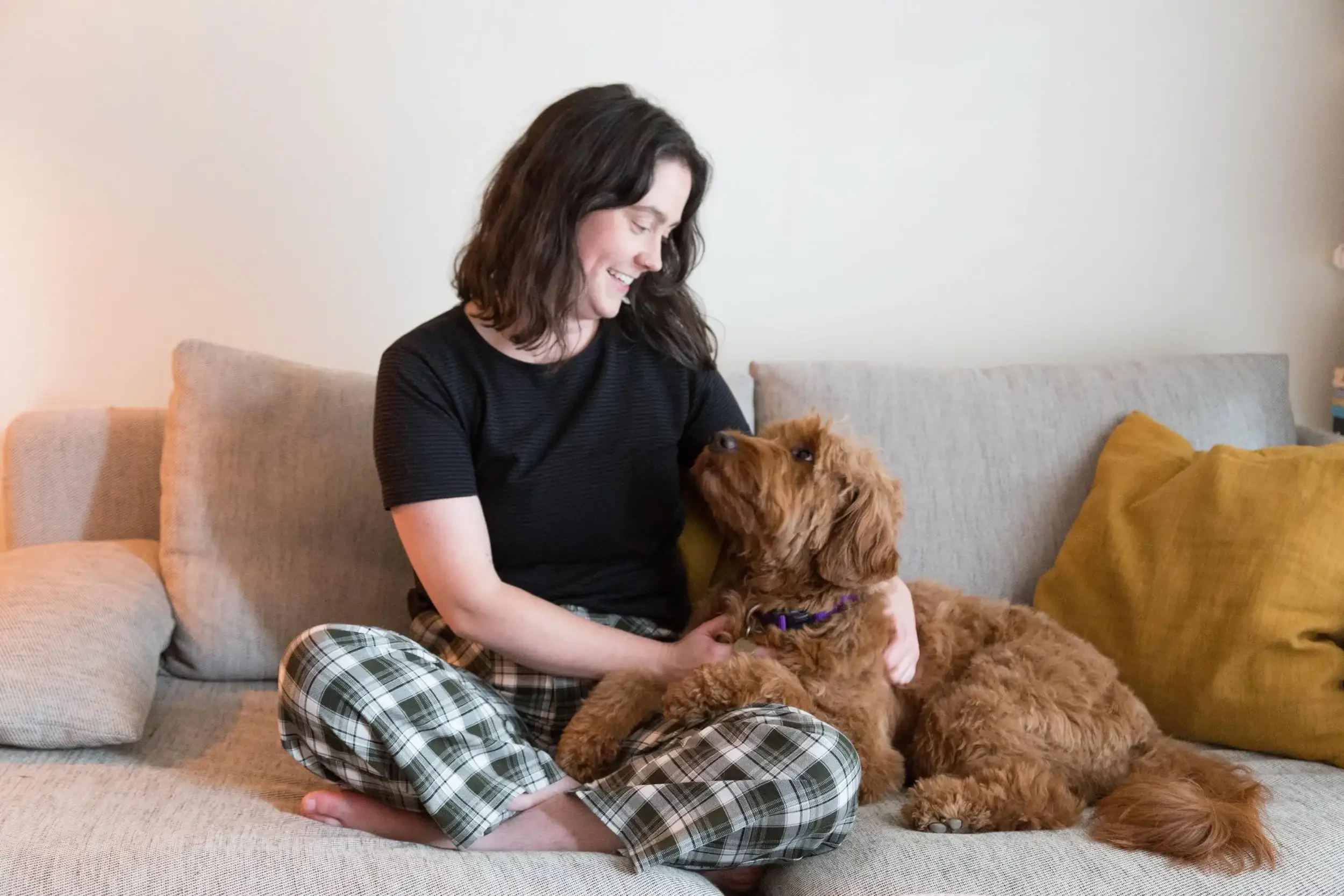 photo of Kate with her dog Rudi sitting on a couch