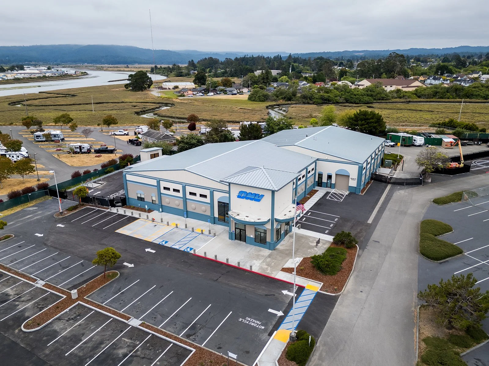 Aerial view of new Eureka DMV showing new site work, flagpole, and entry.
