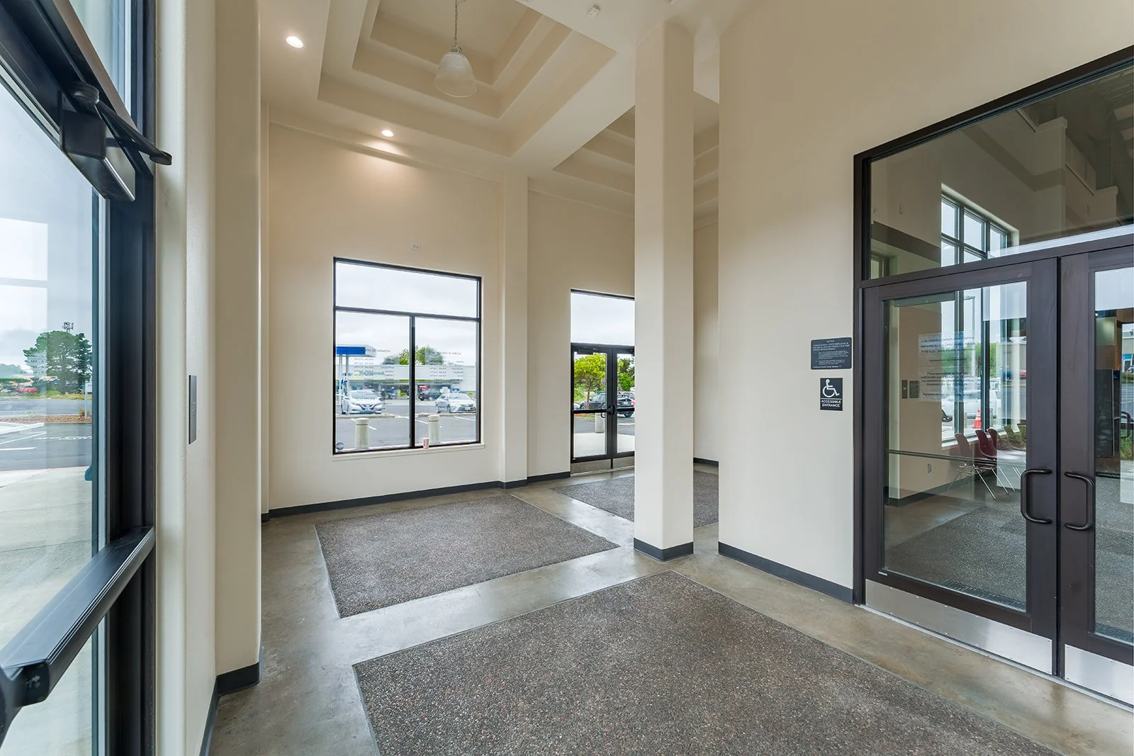 DMV entry vestibule with concrete aggregate floor. 