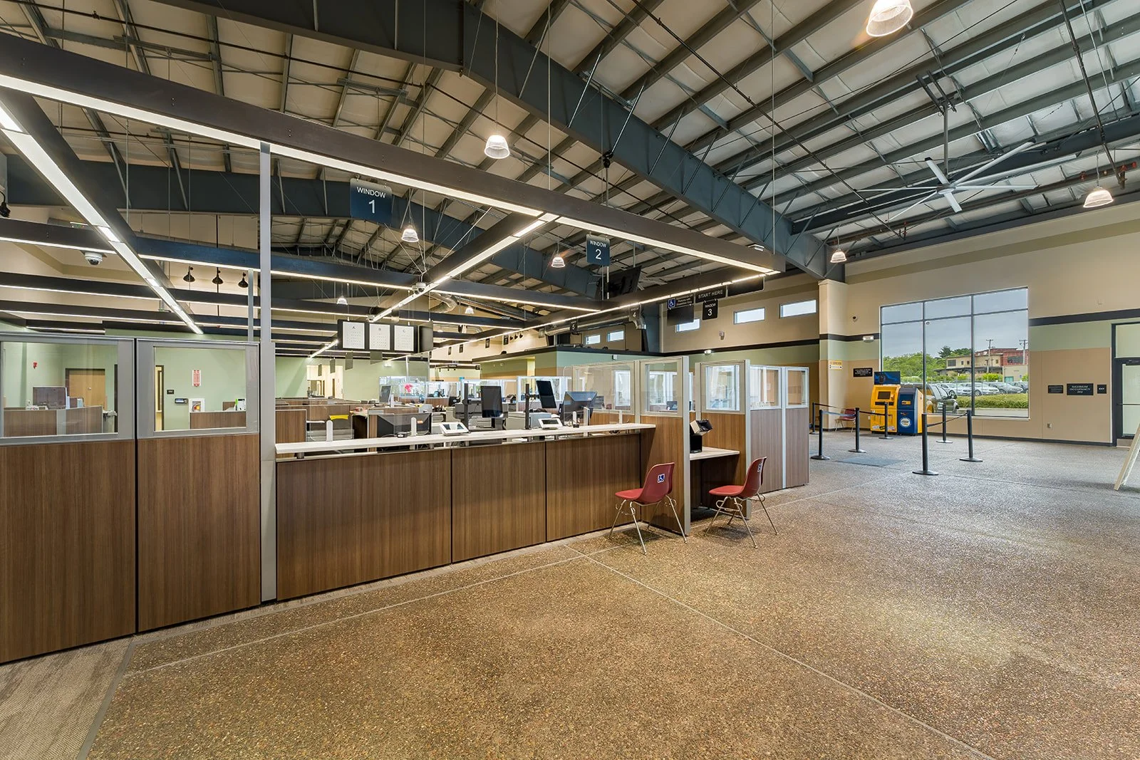 Work stations with lit grid ceiling frame above. 