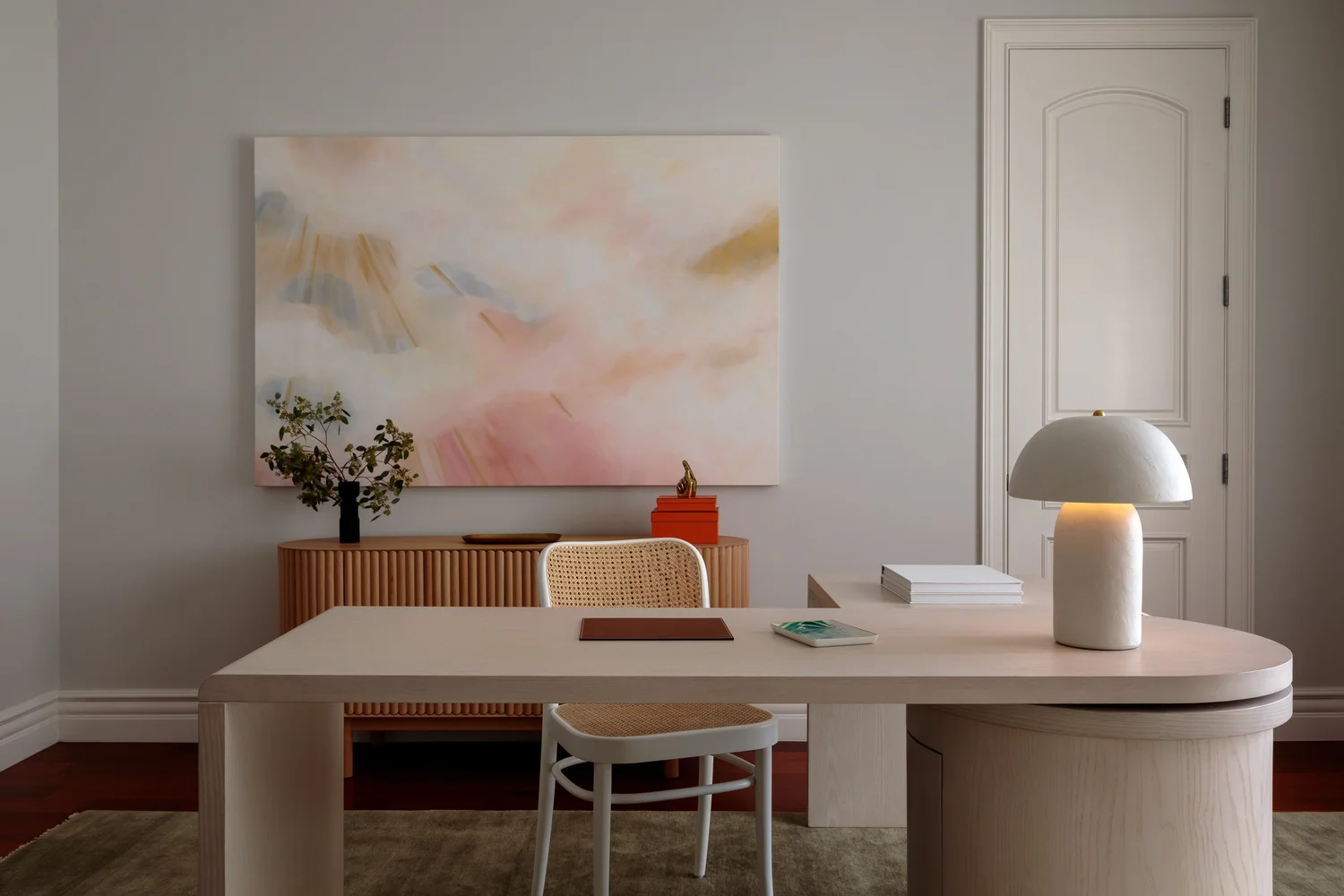 Interior seating moment with sculptural furnishings and warm neutral palette