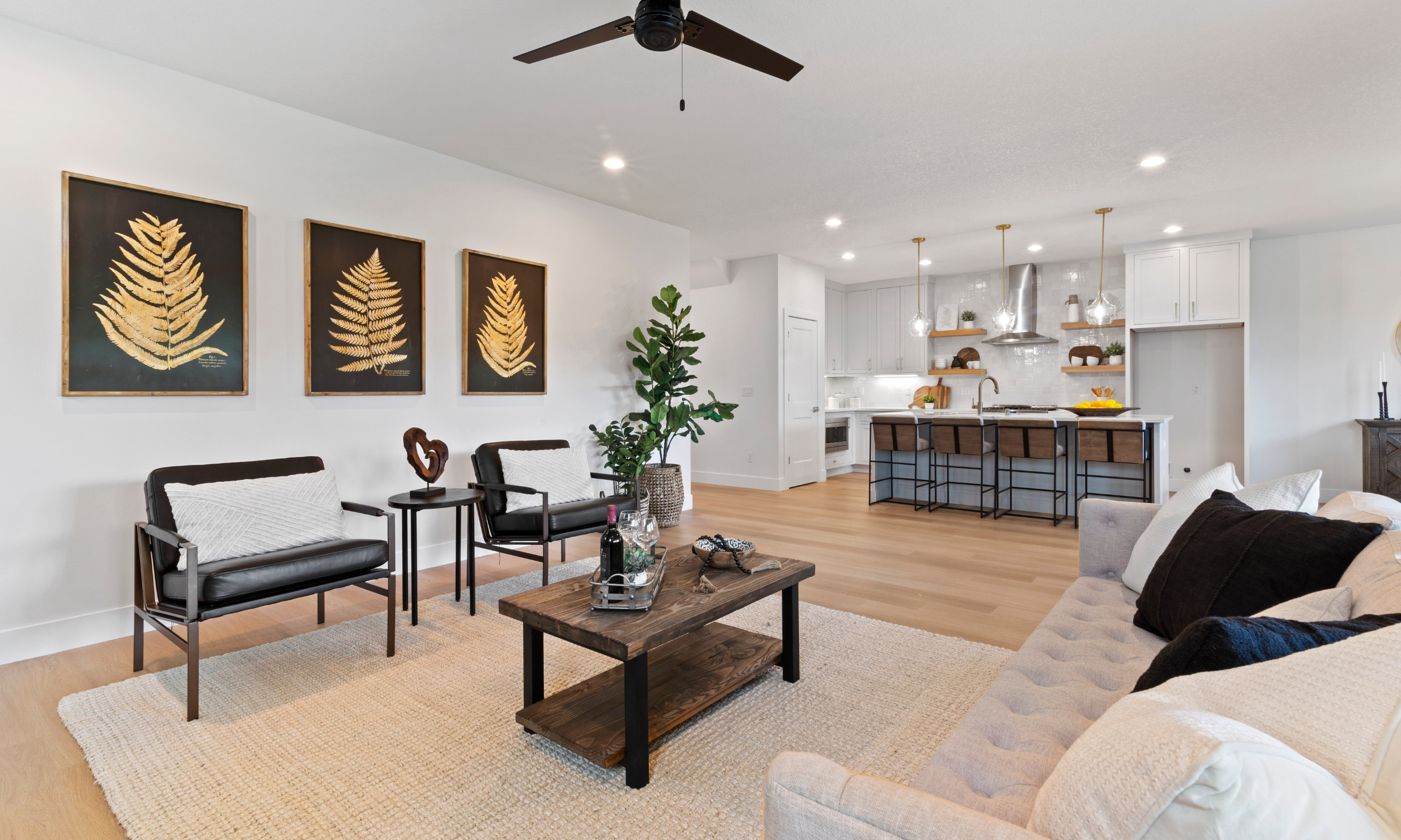Staged living room with kitchen in the background