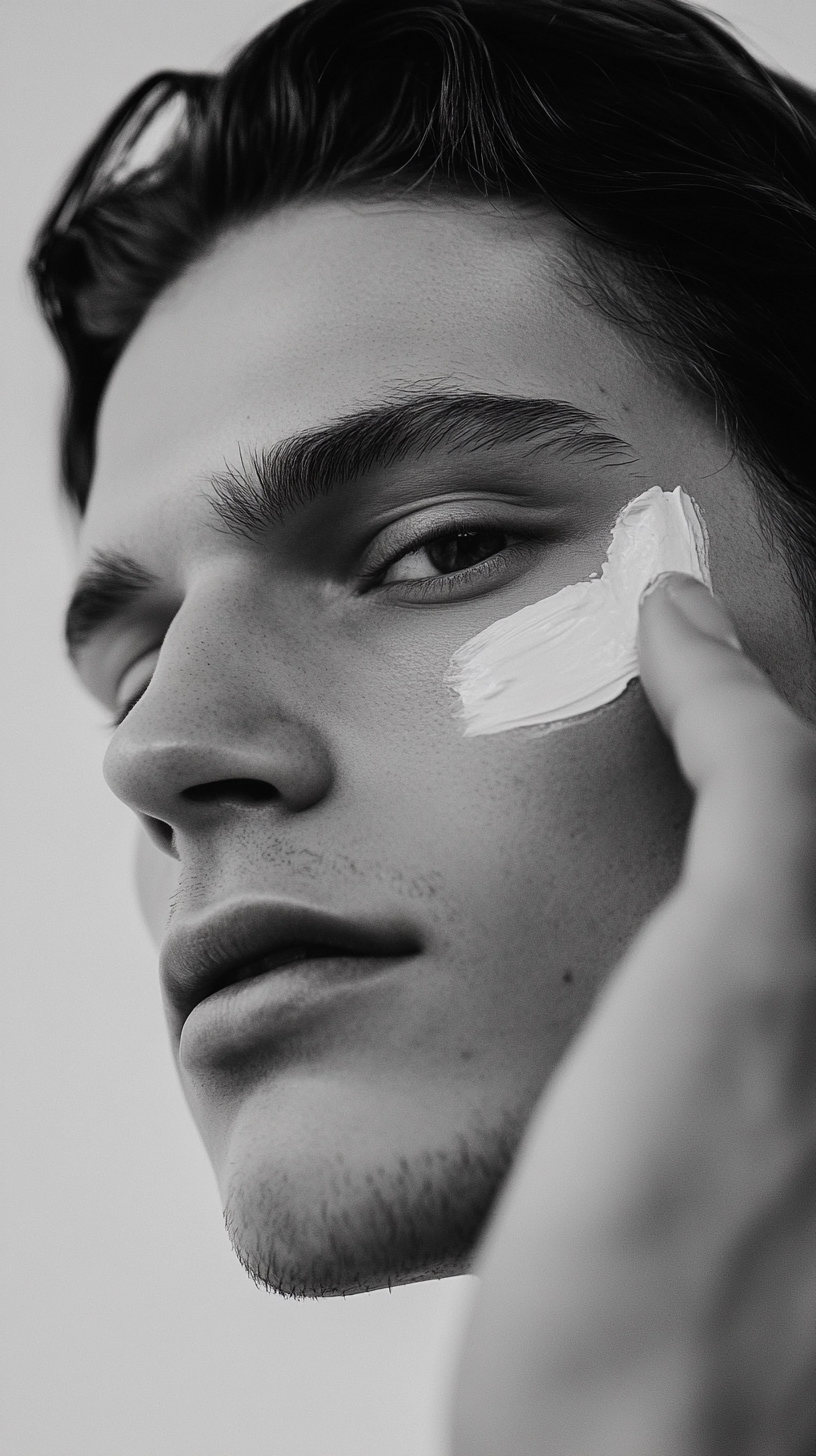 mens-skincare-man-applies-cream-face-smiling-happily-man-uses-skincare-products.jpg