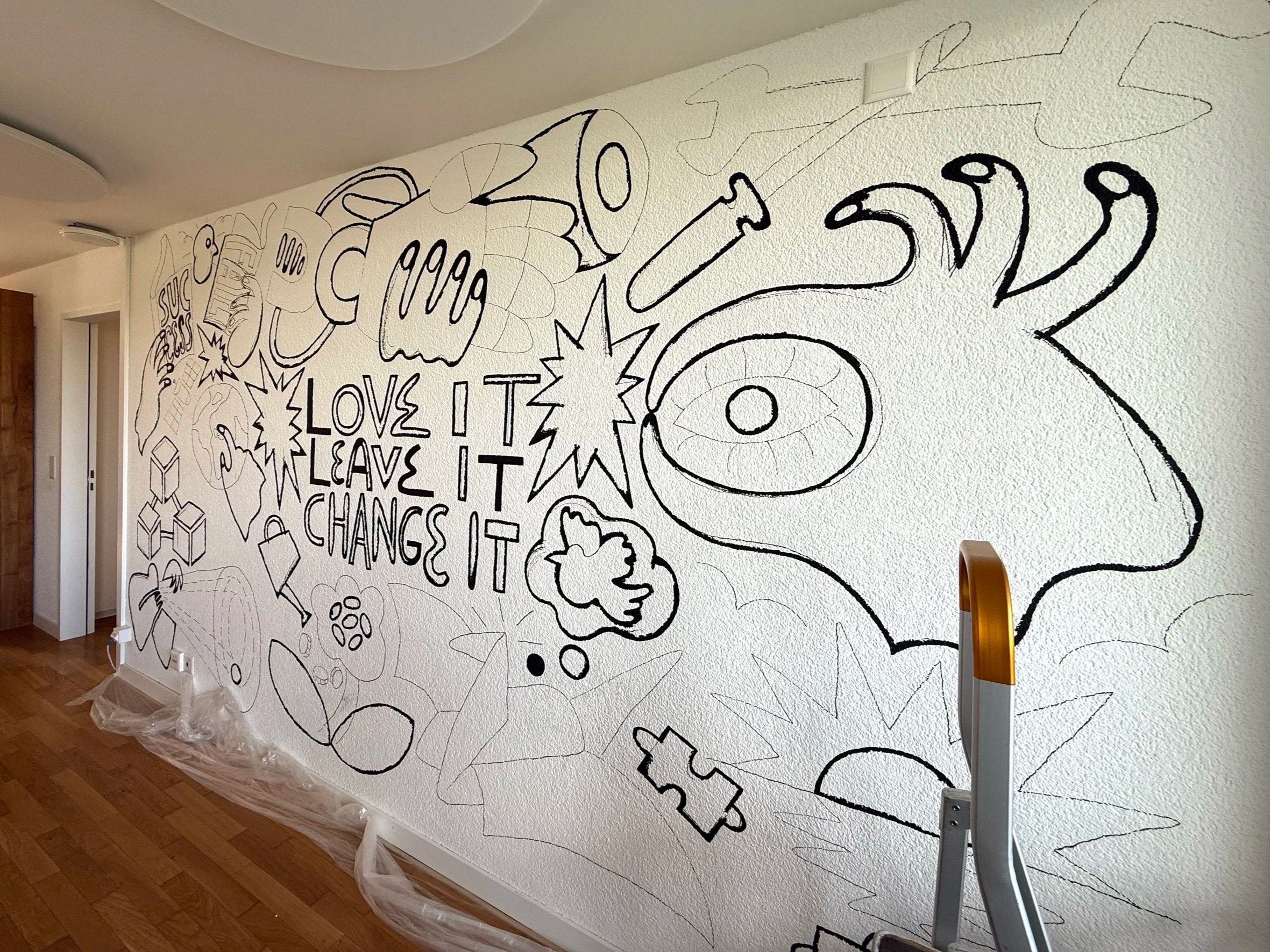 Office wall mural created by Tokyo-born freelance illustrator Sayori Wada in Zurich, featuring bold colors and graphic design elements