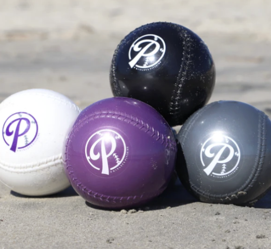 Four bocce balls of different colors on a sandy surface, with logos on each ball.