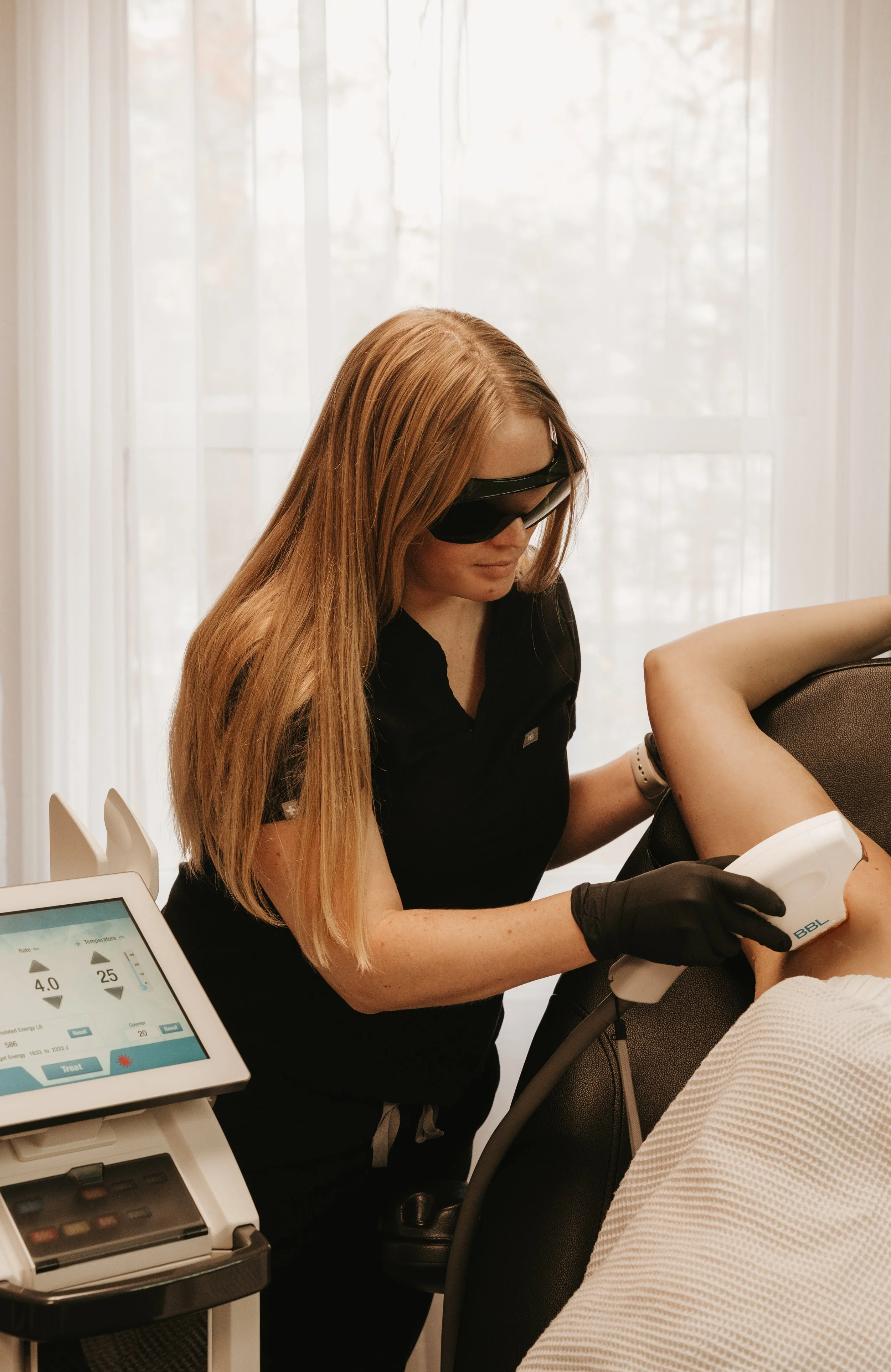 Provider treating patient with a BBL Broad Band Light Treatment.