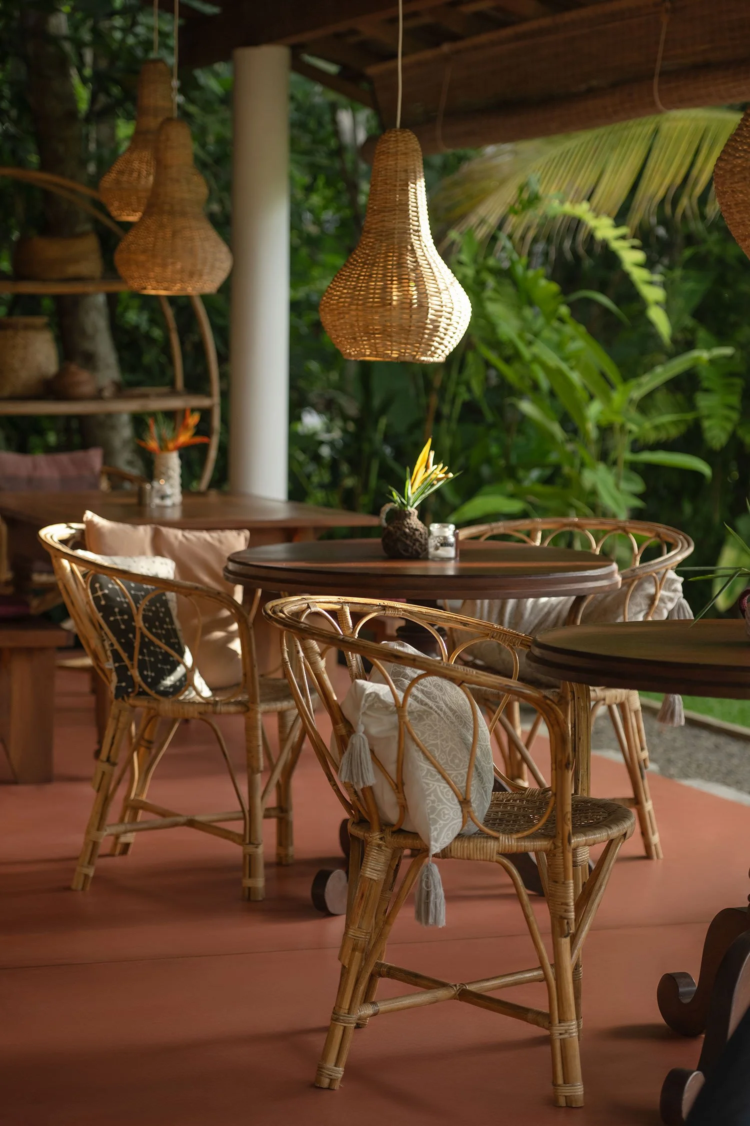 Hanging wicker lamps over outdoor restaurant with wooden tables — Casa Tikiri Boutique Hotel, Ahangama, Sri Lanka