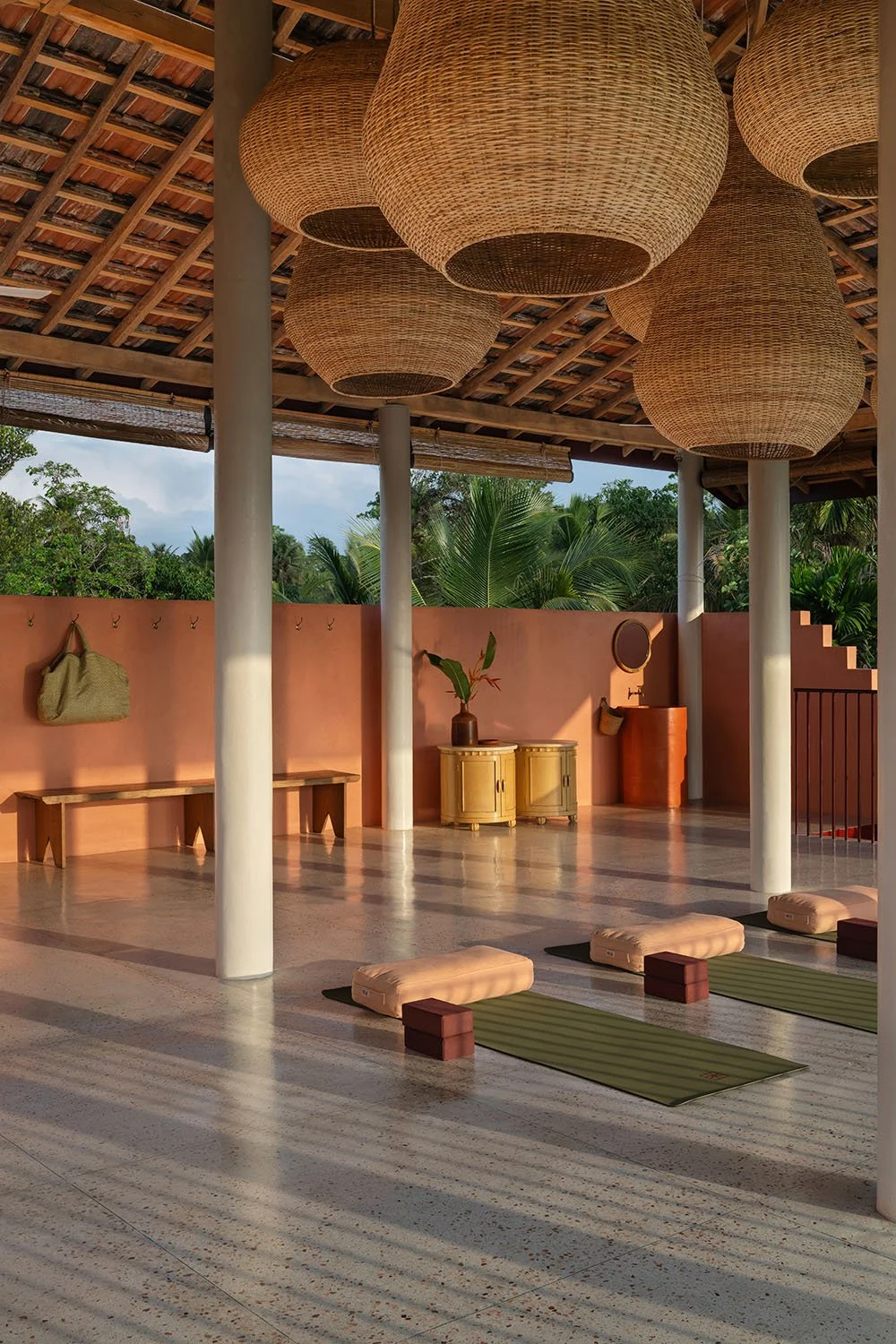 Outdoor yoga studio with mats and cushions surrounded by tropical trees — Casa Tikiri Rooftop Shala, Ahangama, Sri Lanka