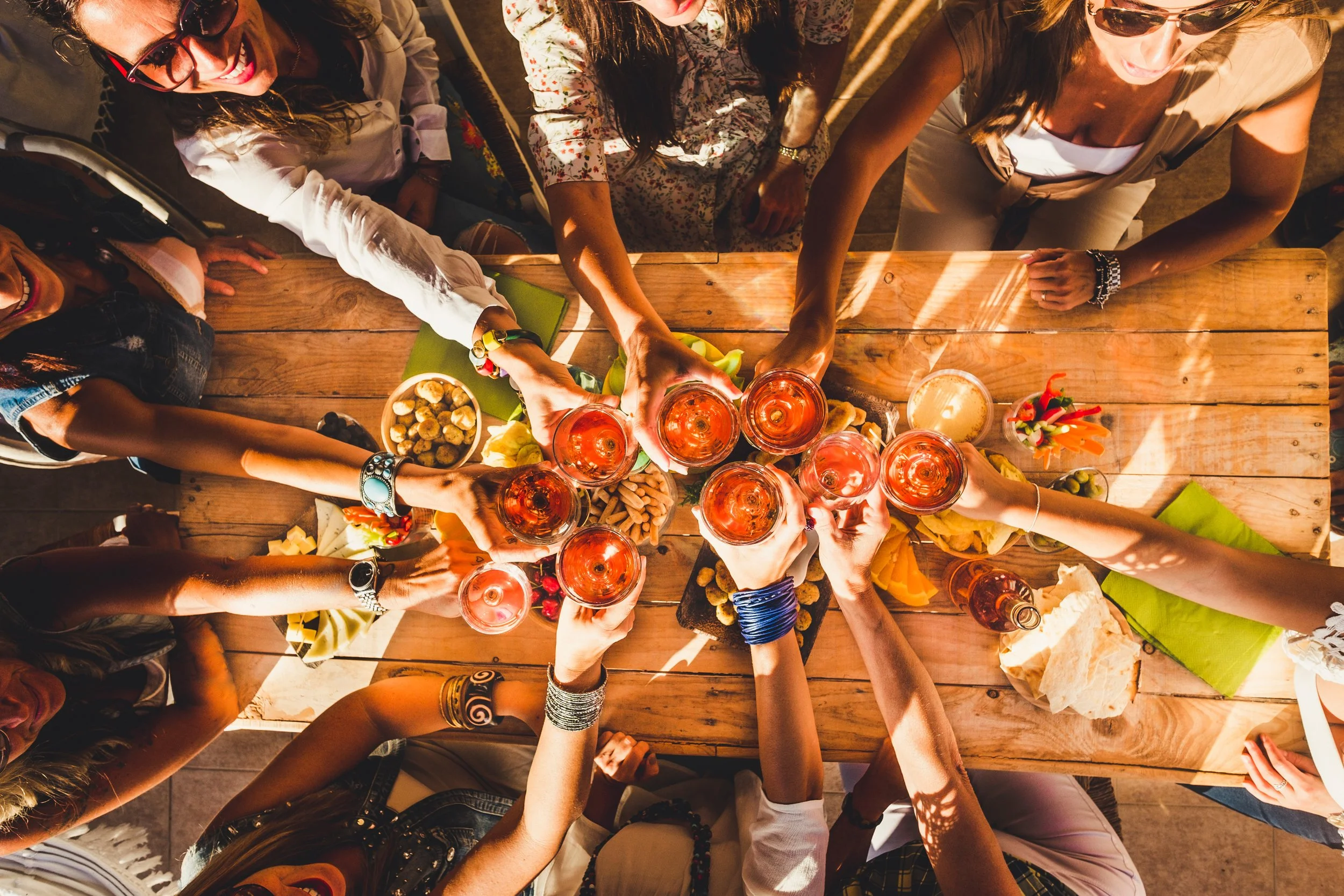 Above view group of friends people enjoy food and drinks toastin