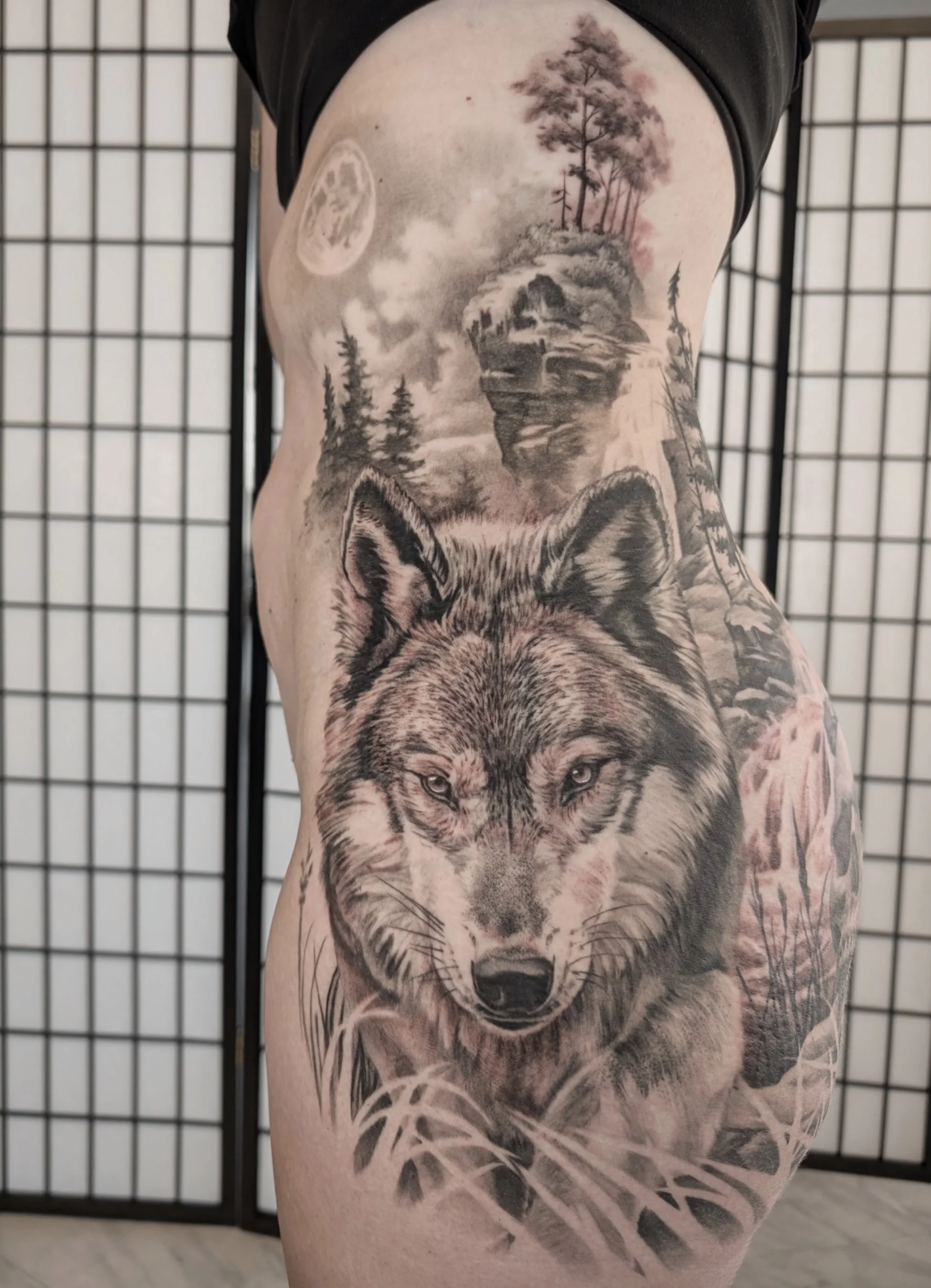 Realistic wolf stalking in the grass hip butt tattoo