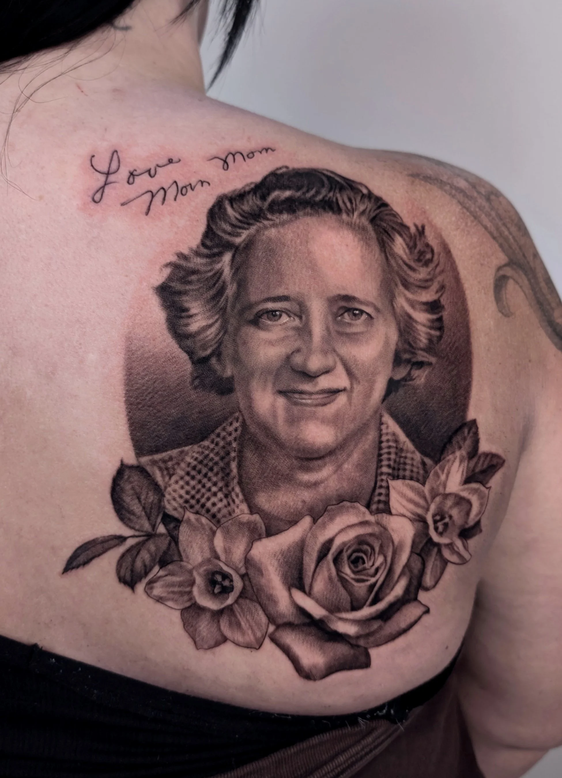 Memorial portrait tattoo of mother with roses and signature from card - "love you, mom"