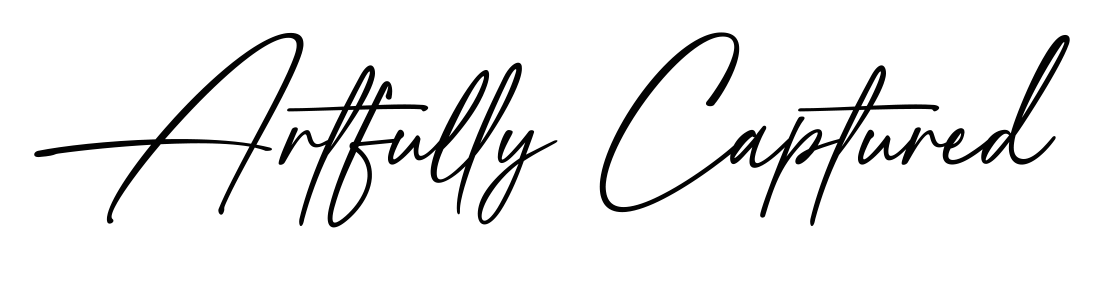 The image contains an artistic design with the handwritten phrase "Artfully Captured" on a black background, featuring a colorful rainbow light effect.